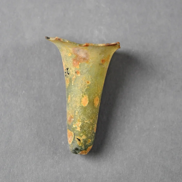 Only the narrow bottom of this lamp survives