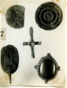 Photograph depicting a number of jewelry items from the 1922 excavation season of the Northern Cemetery tombs. The Rider Saint Amulet is depicted upside down in the lower left corner.