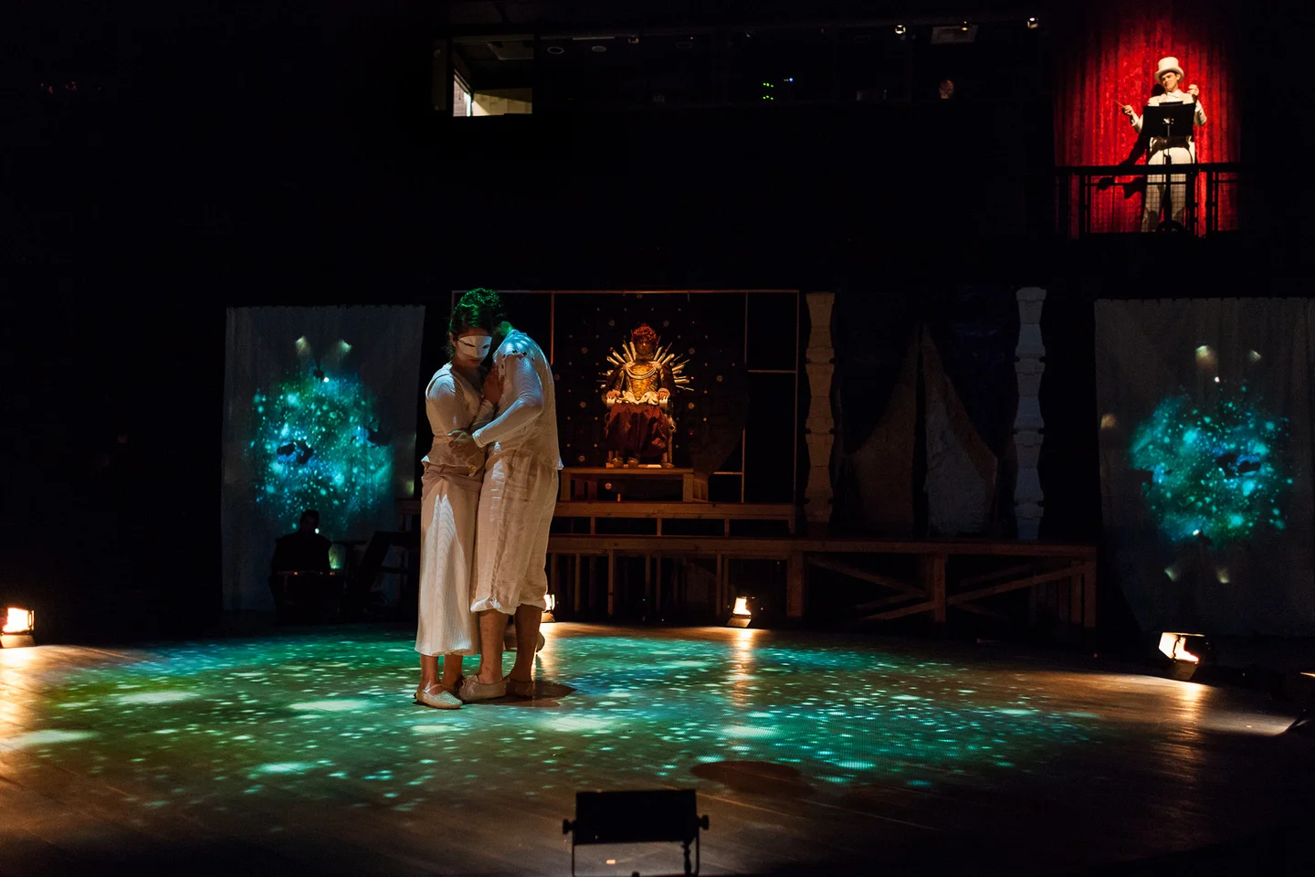 Elizabeth (Regan Linton) watches as God (Matt MacNelly) conducts the Earth (Christian Huerta-Murillo) and Moon (Lindsay Shield).