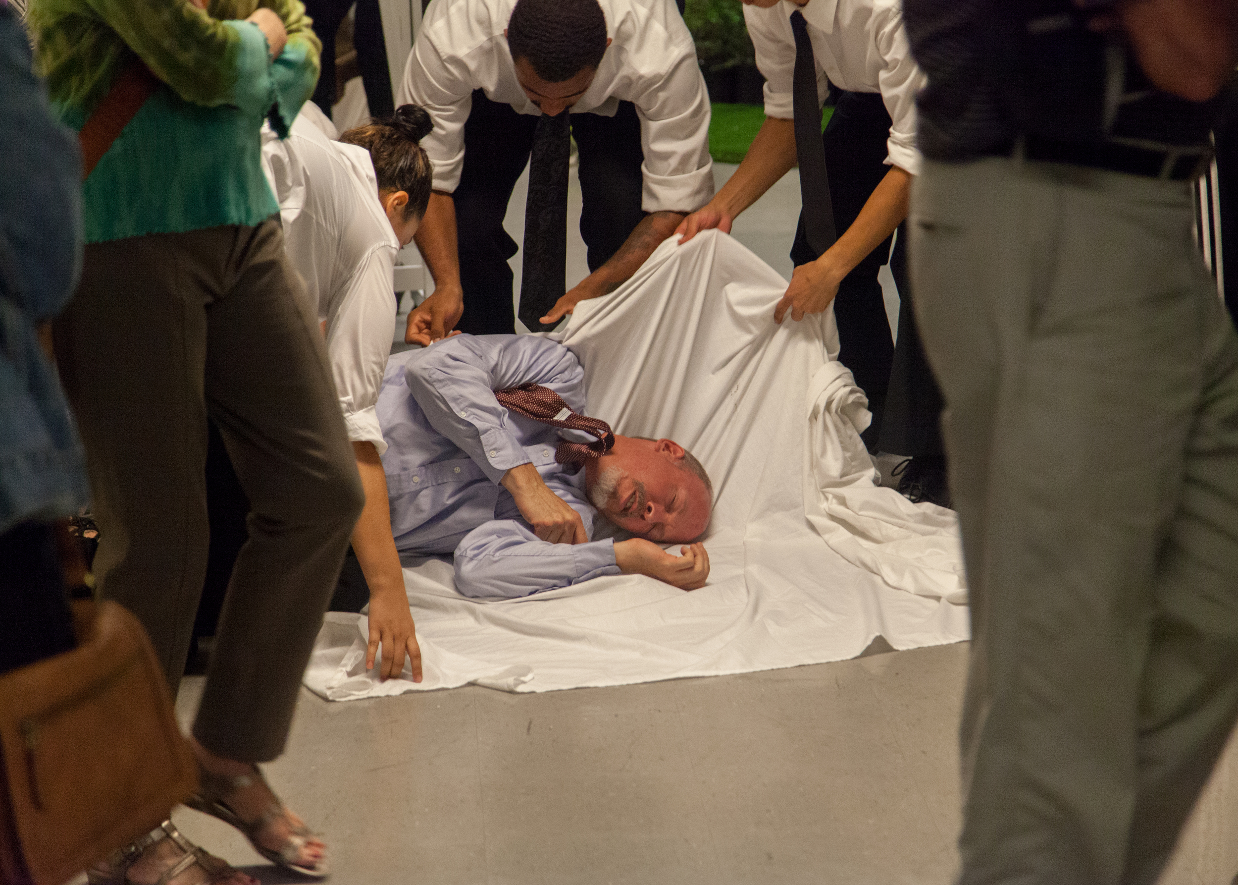Polonius' (Mike Sears) body is quickly dispatched with after he is shot by Hamlet.