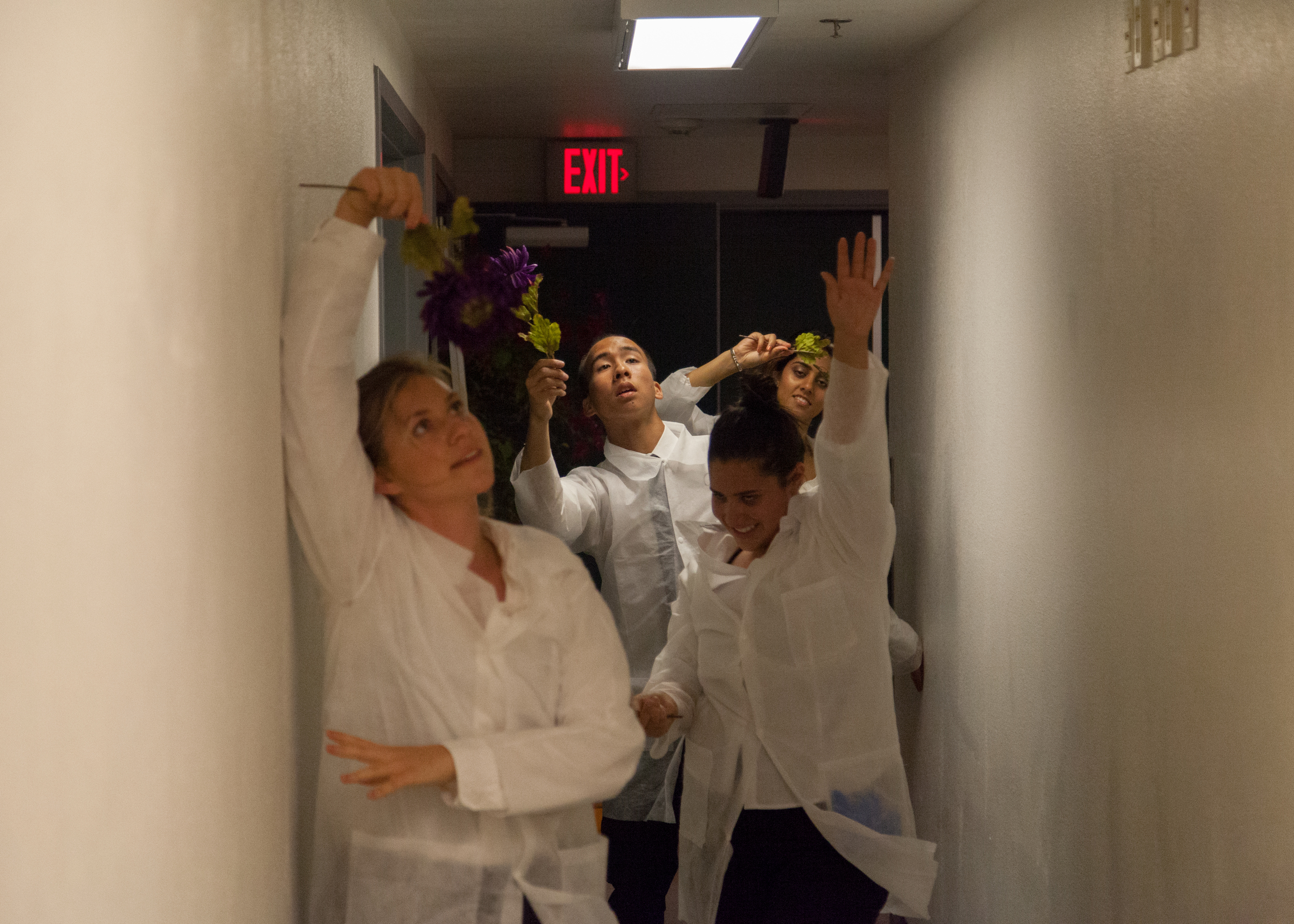 Once Ophelia has accepted her madness, the doctor's dance with flowers down the hall. (Miranda Dainard, Elisa Leveratto, Jeffrey Chan, Ruchi Thukral)