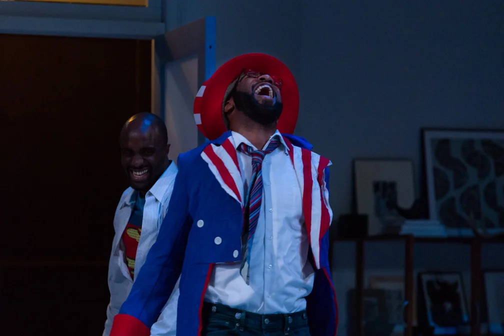 A very drunk Rank (Ronald Washington) comes to say a final goodbye to Torvald (Toby Onwumere) and Nora after the costume party.