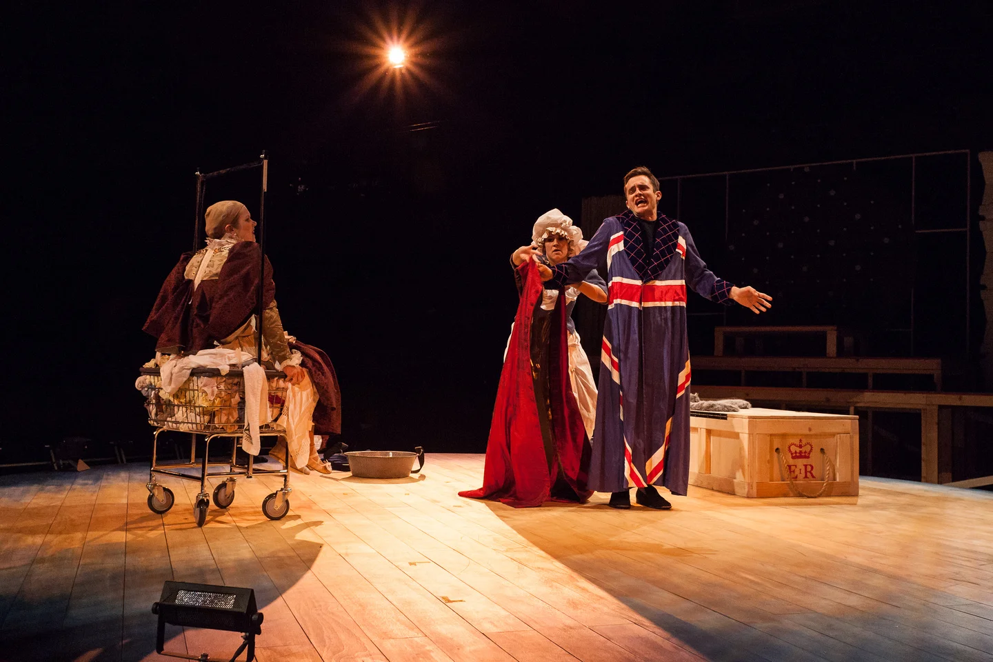 The laundress Tilly Boom (Sarah Halford) arouses Archibishop Whitgift (Brian Smolin) and Elizabeth (Regan Linton) by dressing them in their symbols of power.