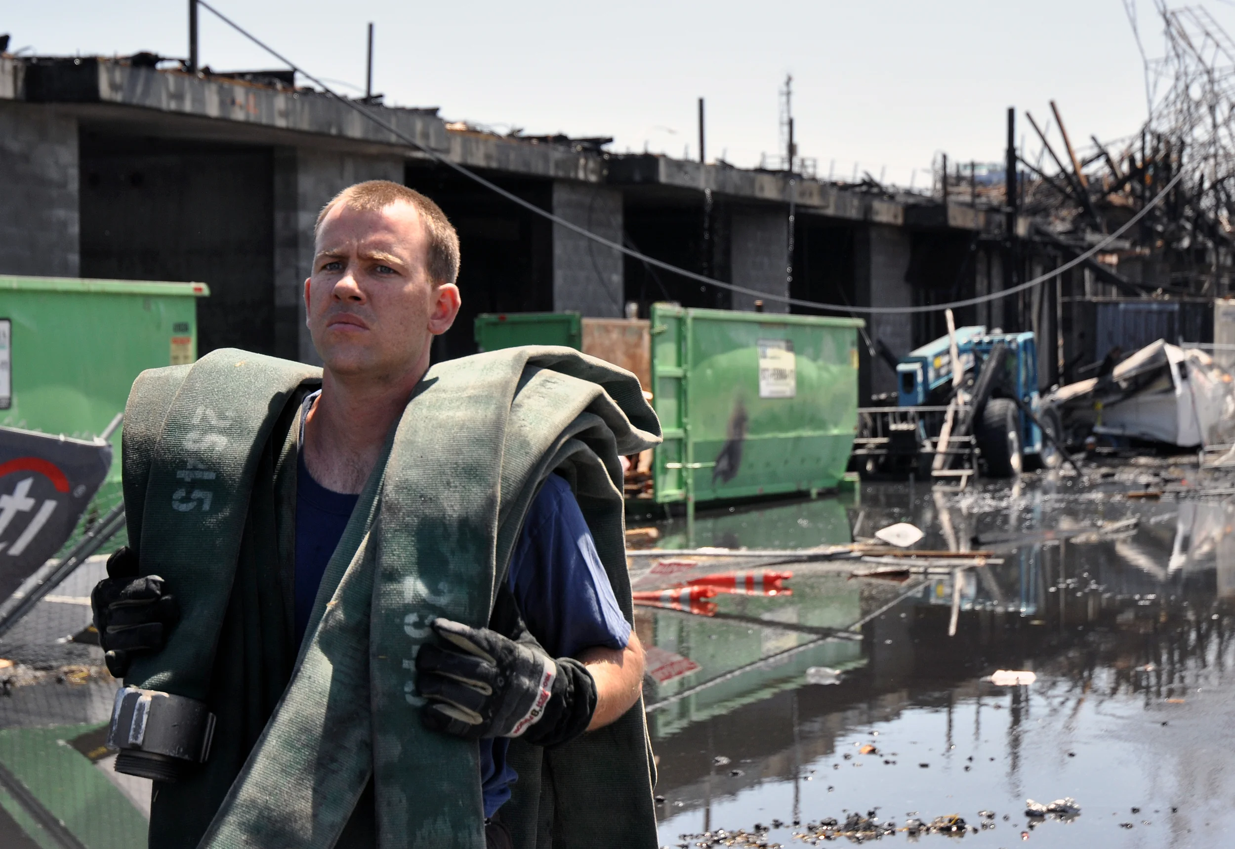  An Oakland Fire Department firefighter gathers equipment after extinguishing the fire that consumed a construction site underneath the West Oakland Bart Station in Oakland, Calif., Thursday, June 14, 2012. Firefighters were called to the scene soon 