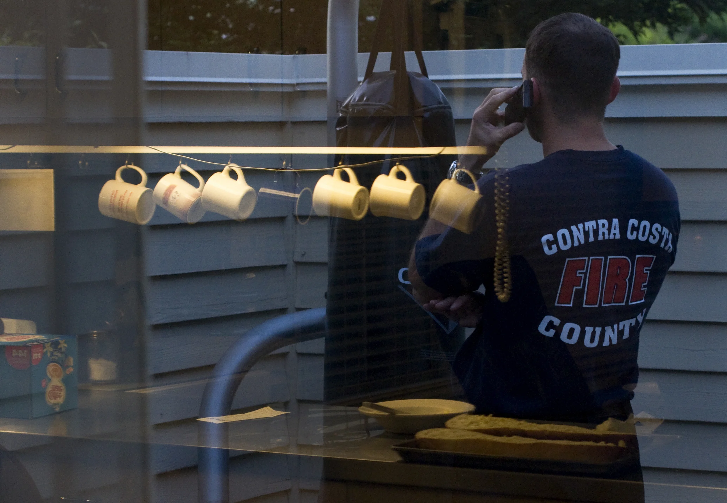  Contra Costa County Fire Department firefighter Brett Schooley talks on the phone with his wife after eating dinner with fellow firefighters at&nbsp;Firehouse 83 in Antioch, Calif., on Thursday, May 5, 2011. 