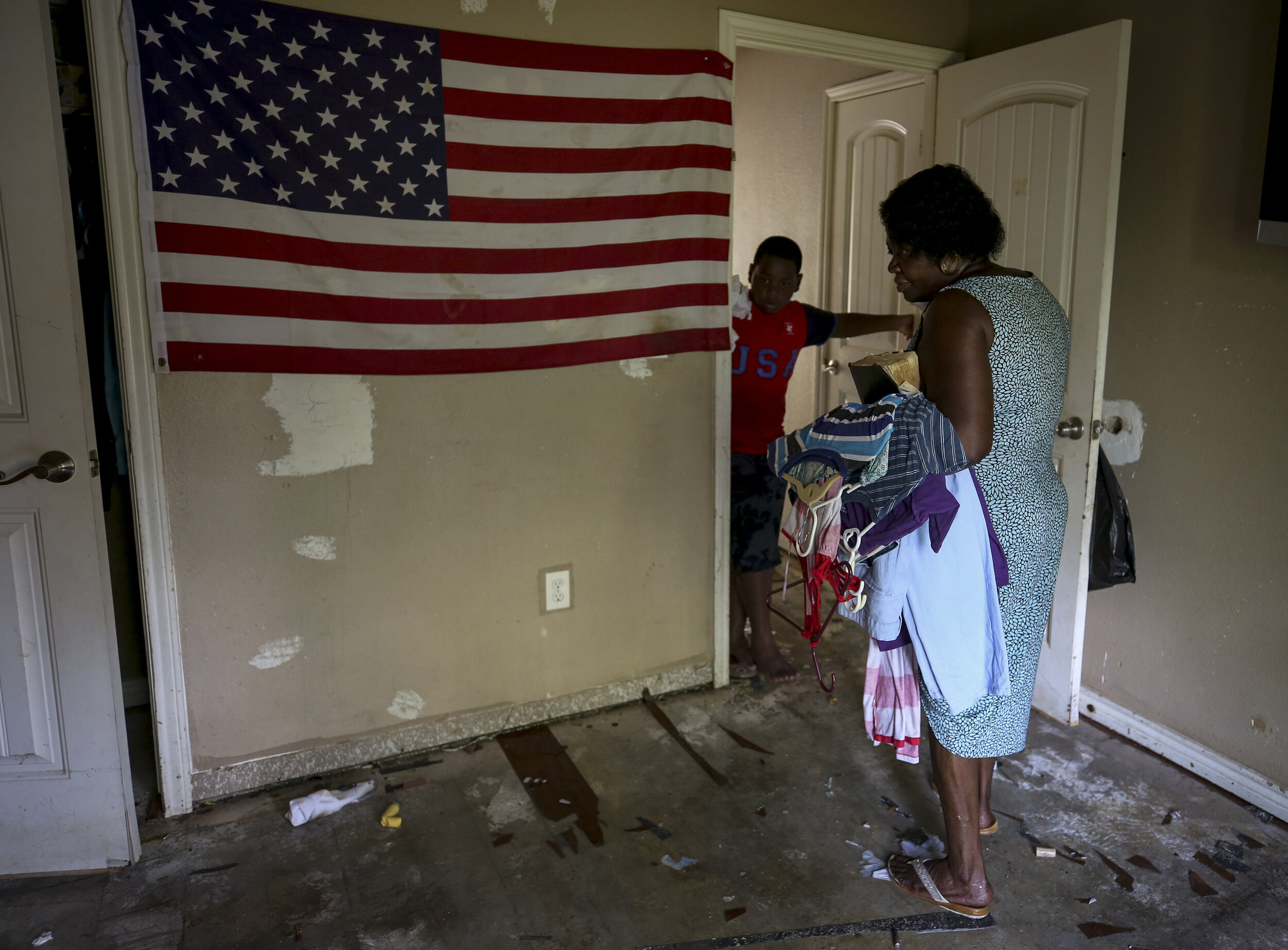  Hilda Robinson, 65, walks through her home after her family helped with cleanup Sunday, Sept. 3, 2017, in Beaumont, Texas. Robinson's home, where she has lived the last 15 years, was flooded with roughly four feet of water according to her family. 
