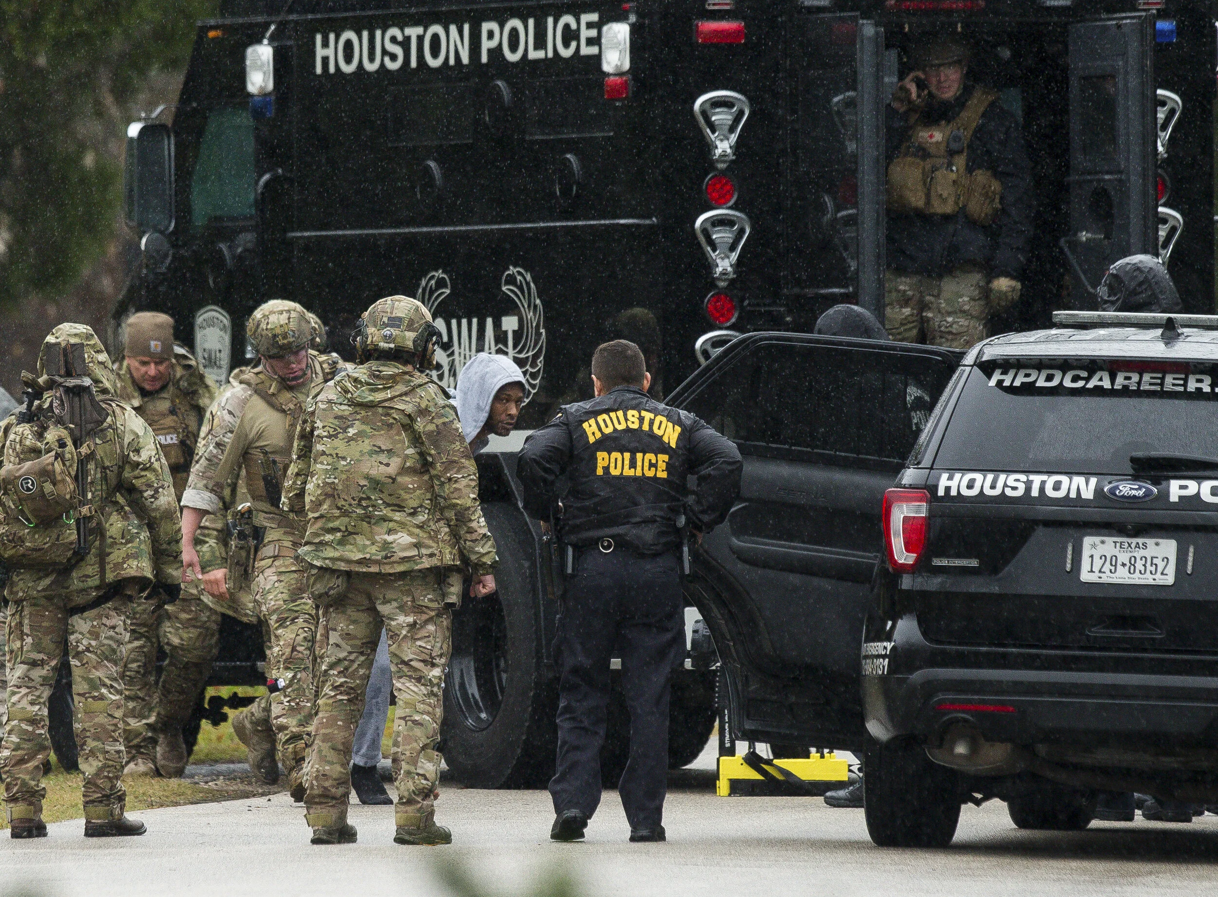  Houston Police SWAT officers take into custody a 36-year-old man who had barricaded himself after stabbing a woman in the face at the 8100 block of Hezekiah Lane on Thursday, Jan.3, 2019, in Houston. Authorities responded to the domestic violence ca