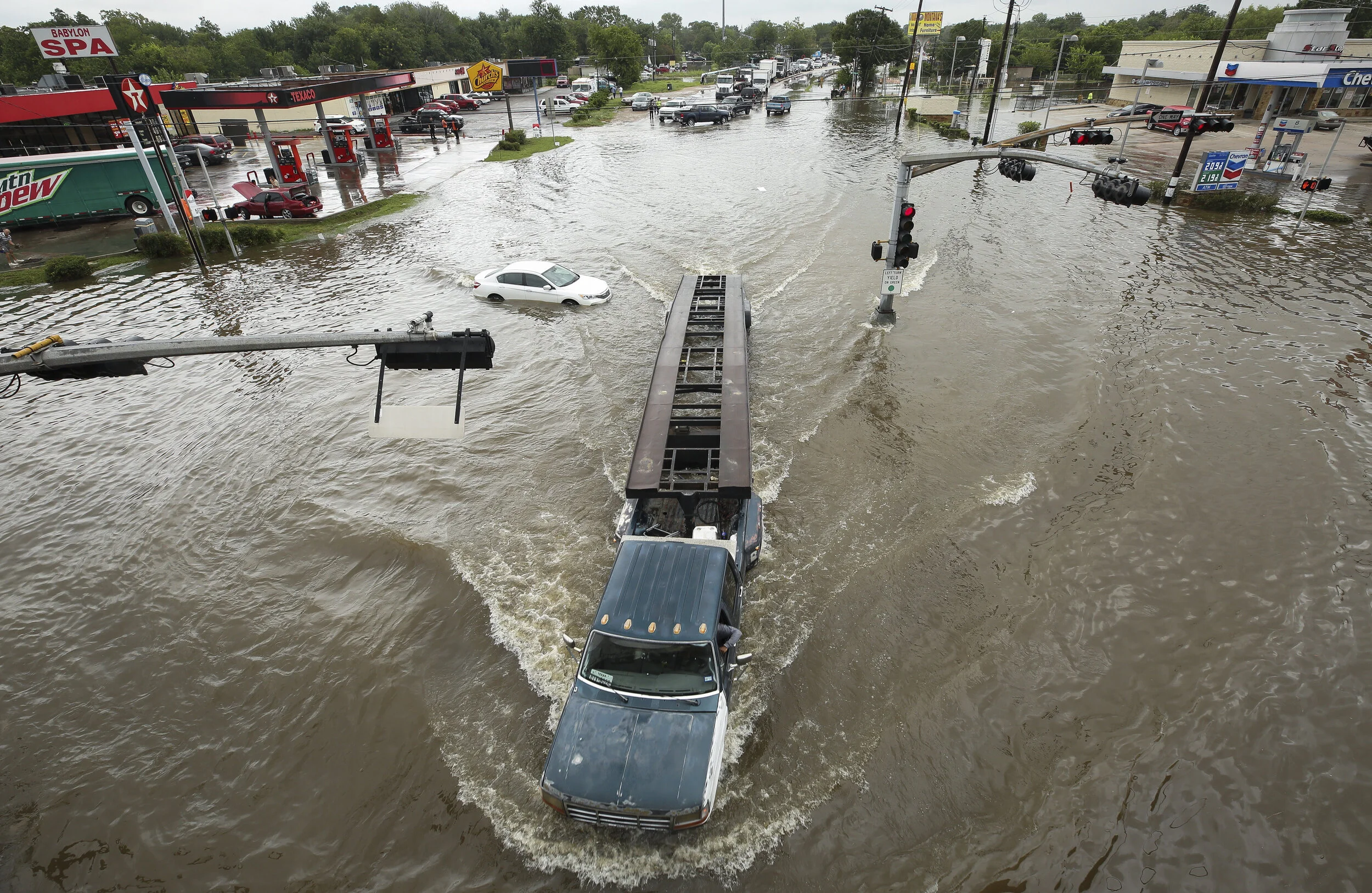 A motorist drives through high water on West Mount Houston Road near Interstate 45 on Tuesday, Aug. 8, 2017, in Houston. 