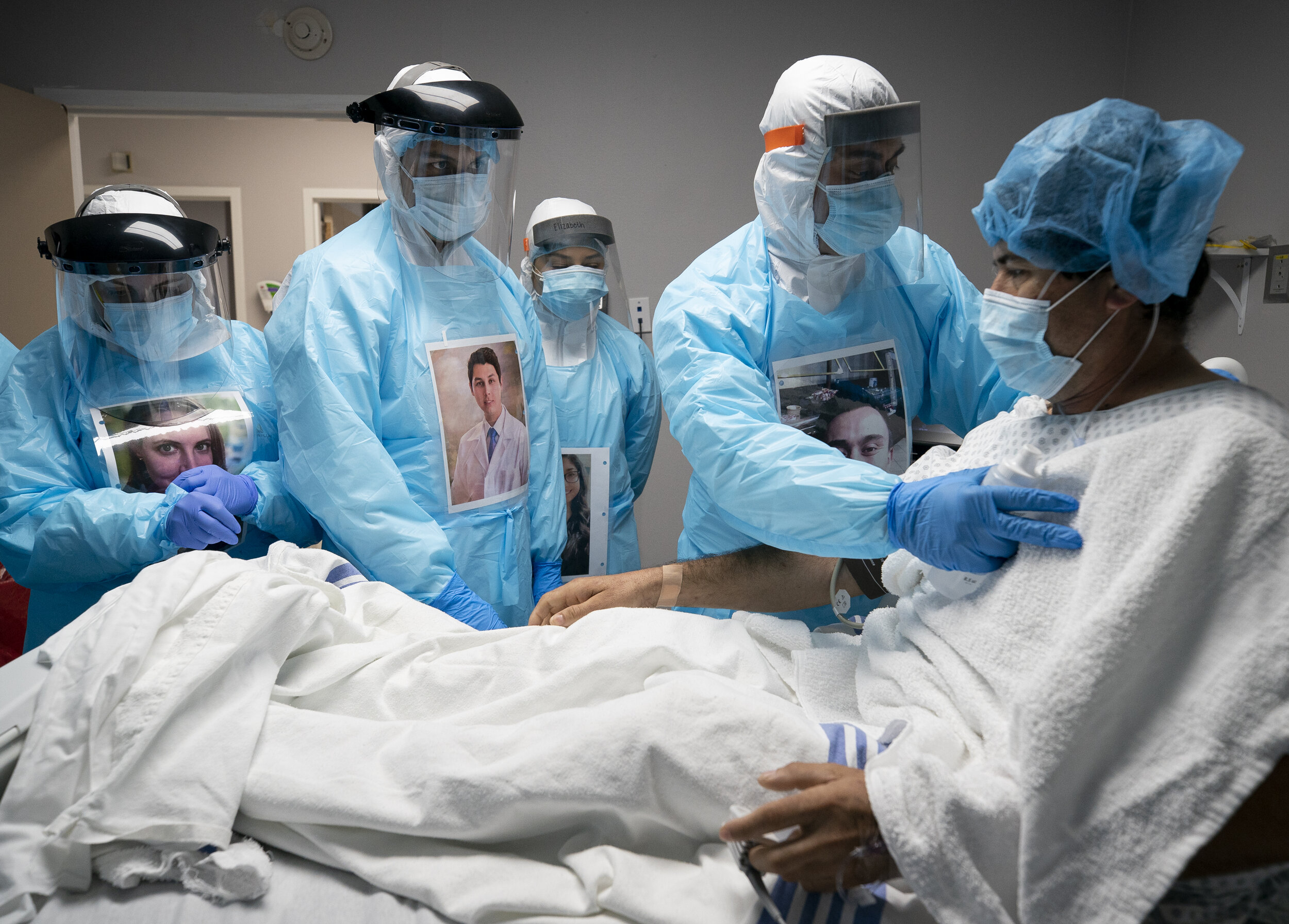  Juan Carlos Peña, 43, is checked on by physicians and nurses before administering an ultrasound on his lungs at United Memorial Medical Center's COVID-19 intensive care unit on Tuesday, April 28, 2020, in Houston. Peña decided to go to the hospital 