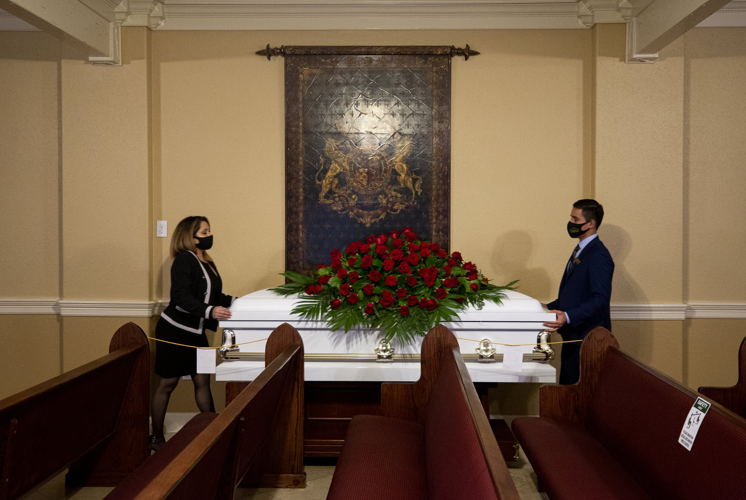  Compean Funeral Home manager Rosa Soto, left, and assistant Dennis Baquedeno, right, move Trancito Rangel's casket out of the chapel after the conclusion of the funeral service Tuesday, Aug. 4, 2020, in Houston. Rangel, 46, was a construction worker