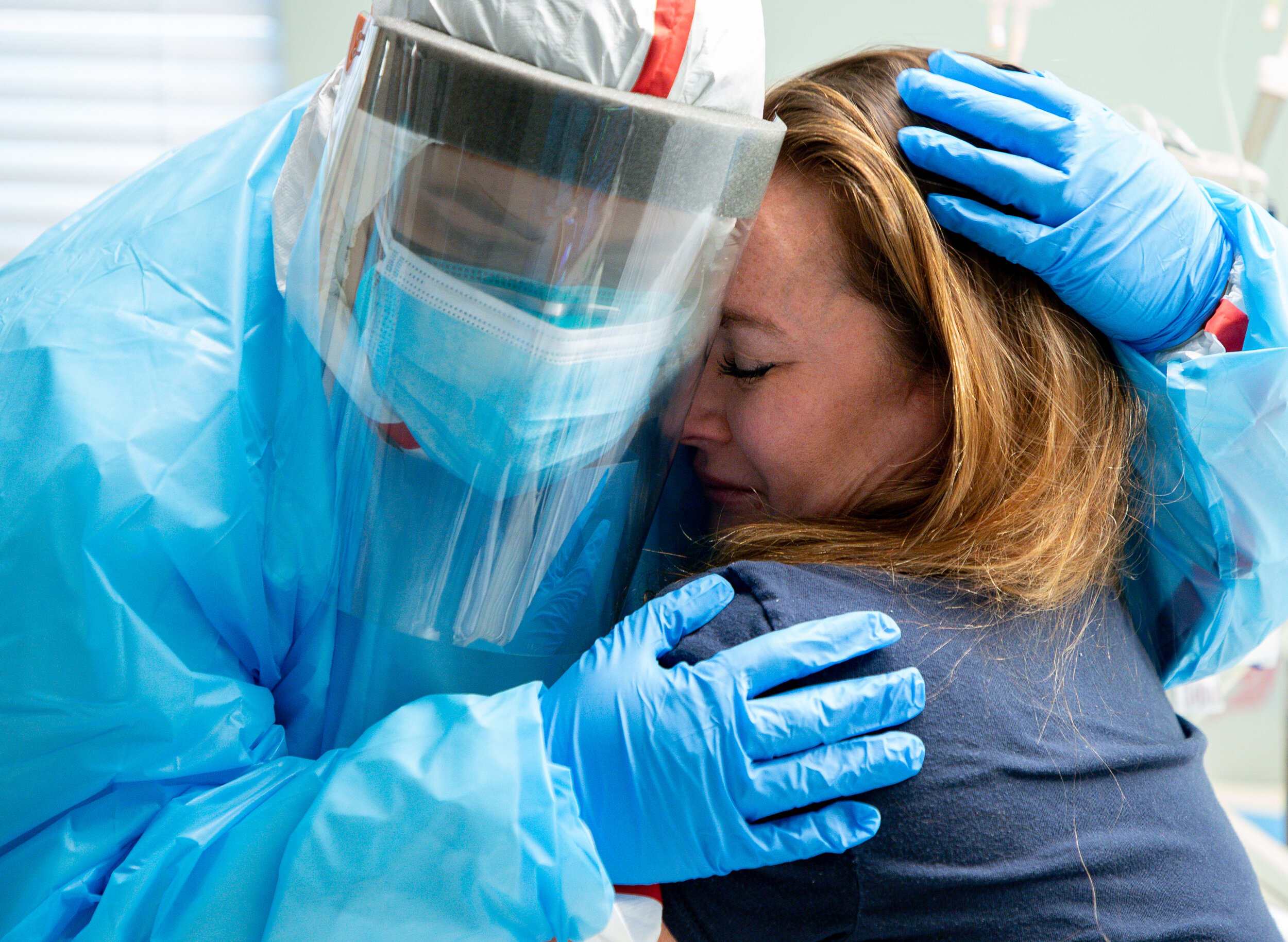  Tanna Ingraham, right, is hugged by medical student Pauleth Tenorio, left, inside her room at United Memorial Medical Center, on Friday, Dec. 11, 2020, in Houston. Ingraham, who is a registered nurse and works at UMMC's COVID-19 intensive care unit,