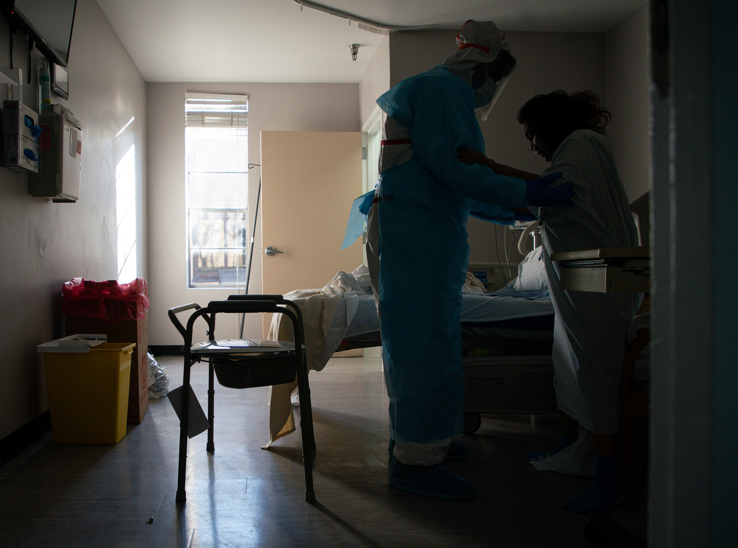  A nurse helps a patient walk, after they had been bed-ridden inside the COVID-19 intensive care unit at United Memorial Medical Center on Thursday, Dec. 24, 2020, in Houston.  