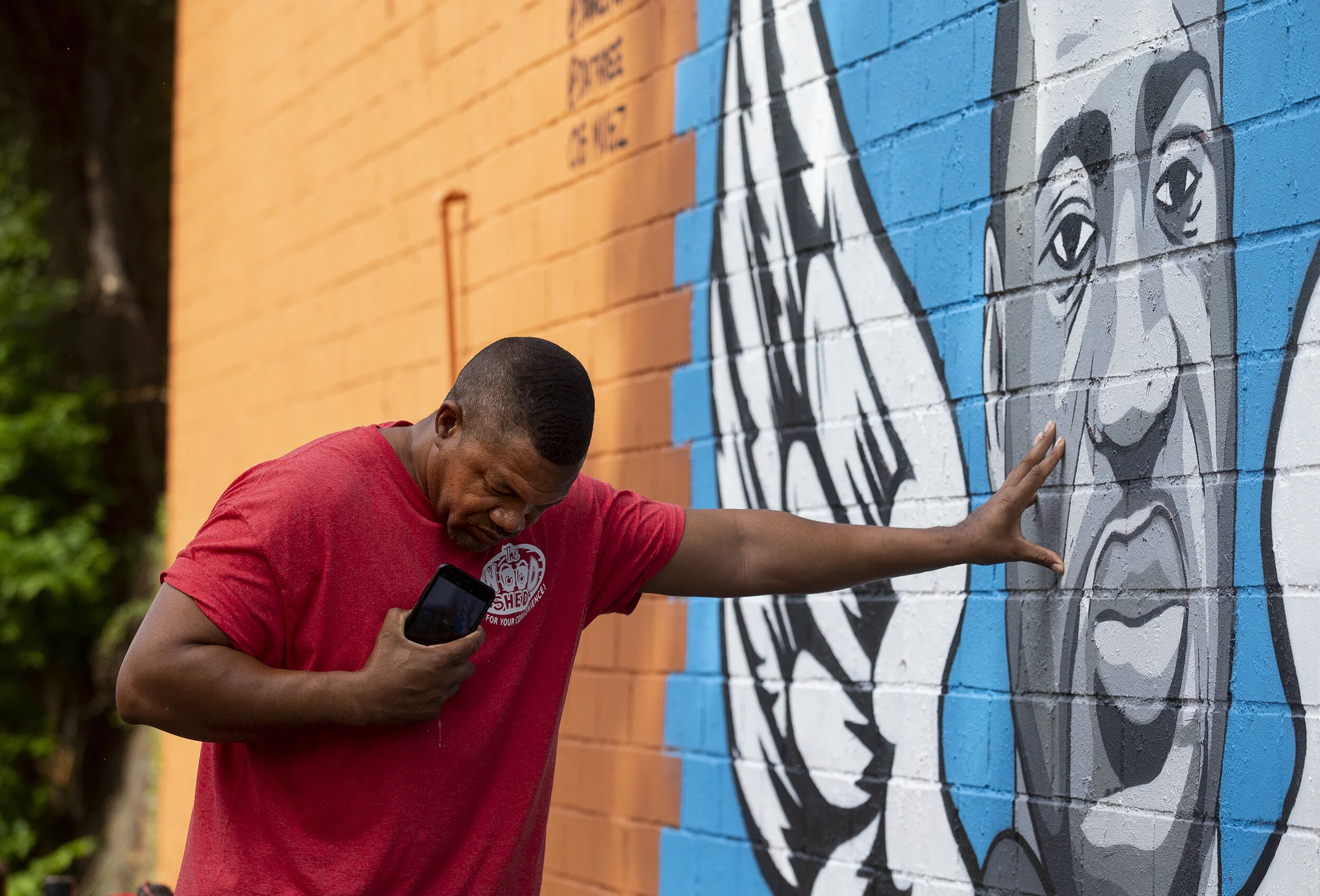  Paul Steward bows his head and touches the mural of foamier Houston resident George Floyd while in a moment of prayer in the Third Ward on Wednesday, June 3, 2020, in Houston. Floyd died in custody of Minneapolis Police officers last week, an event 