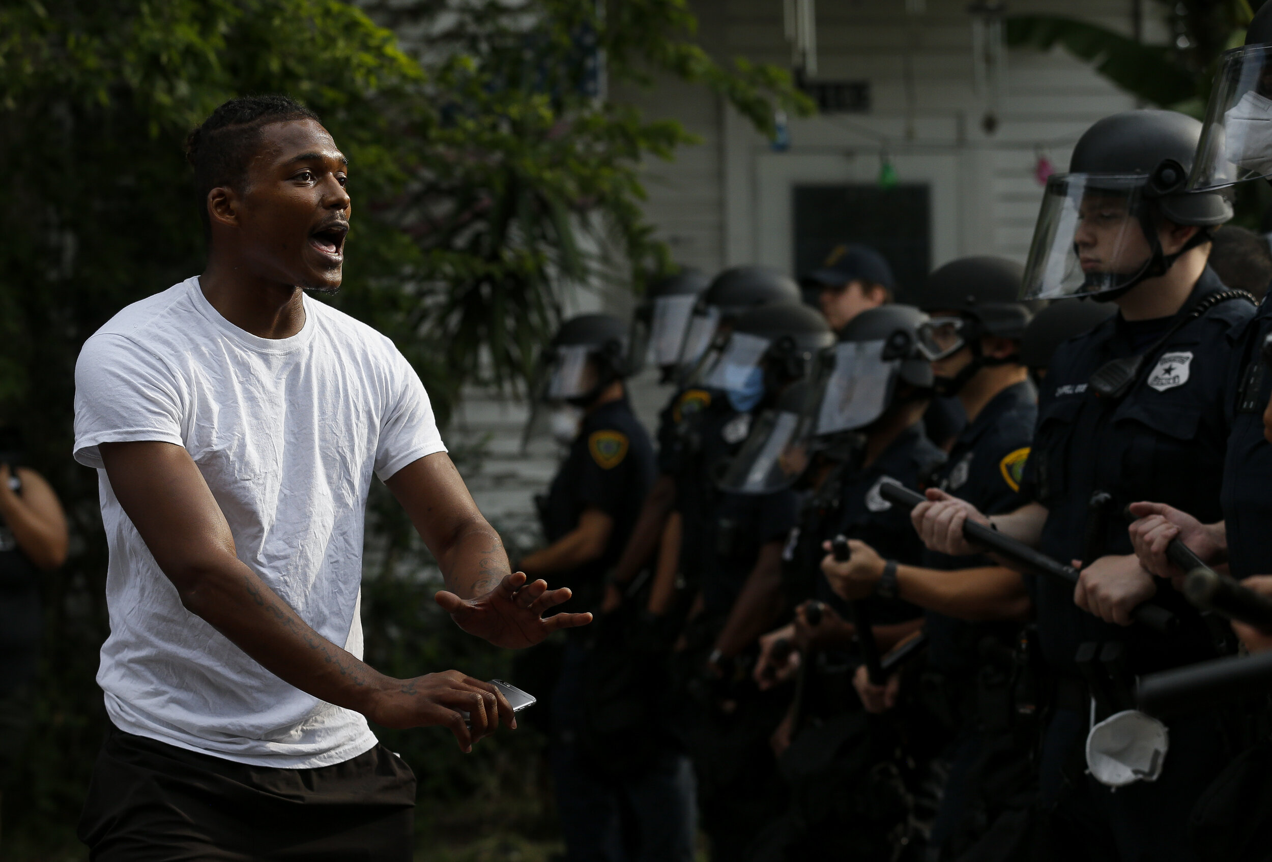  Jordan Hill, left, asks Houston Police officers to remain calm as officers blocked Elgin Street from demonstrators marching in protest of the death of former Houston resident George Floyd on Saturday, May 30, 2020, in Houston, Texas. Floyd died whil