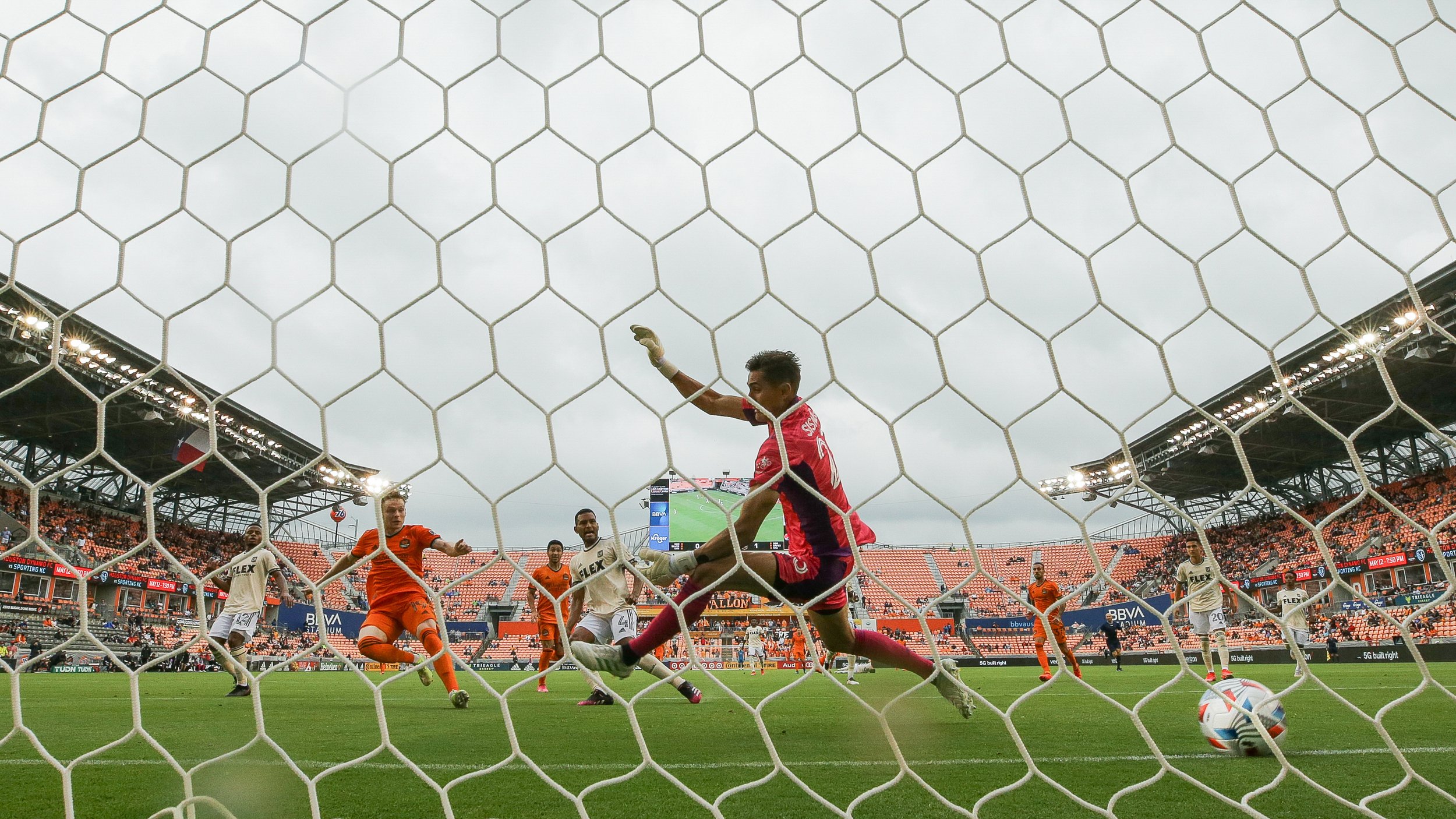  Houston Dynamo FC forward Tyler Pasher (19) scores the tying goal against Los Angeles FC goalkeeper Pablo Sisniega (23) during the second half of an MLS match at BBVA Stadium on Saturday, May 1, 2021, in Houston. The game ended 1-1. 