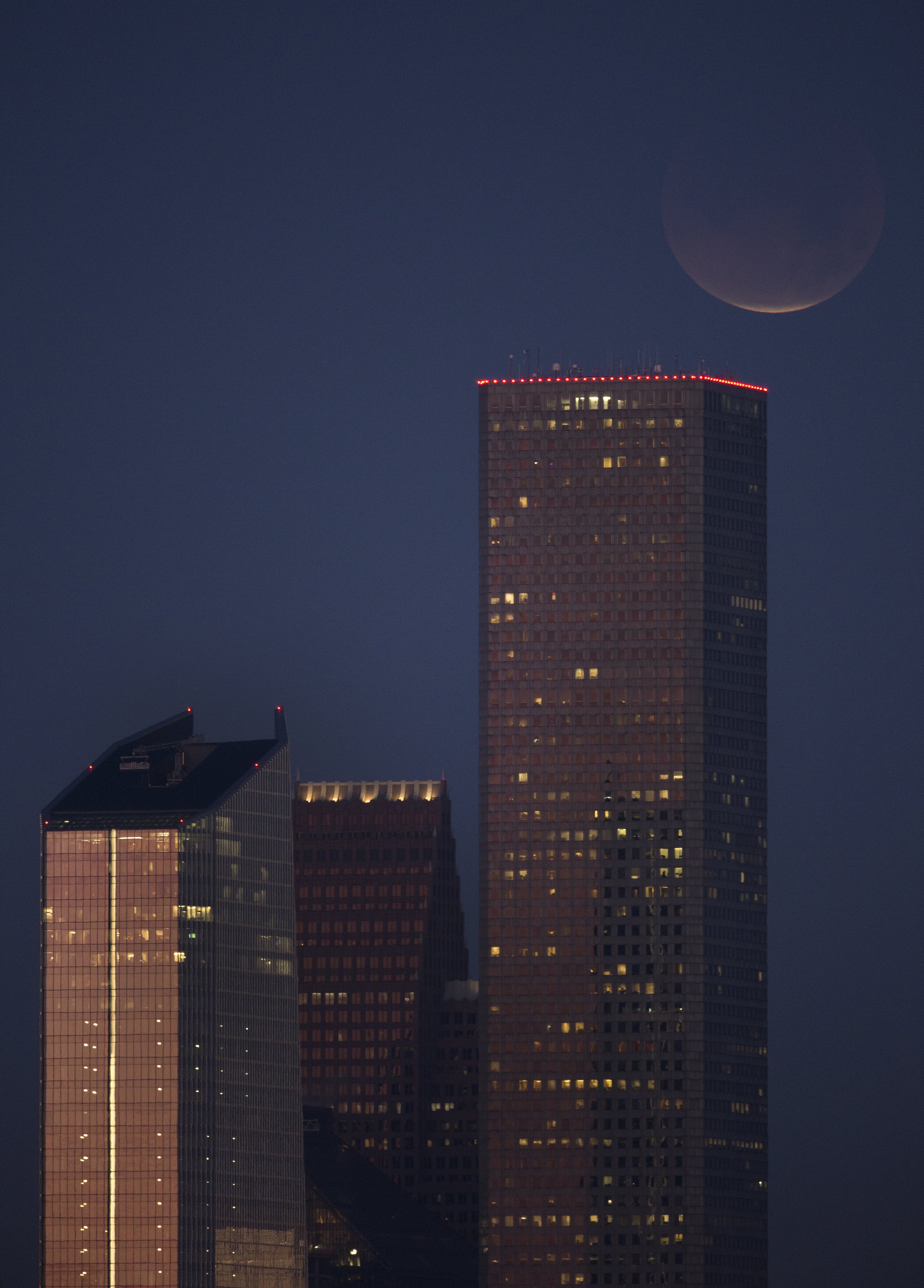  The super blood moon, near full eclipse, seen above the downtown skyline on Wednesday, Jan. 31, 2018, in Houston, Texas. 
