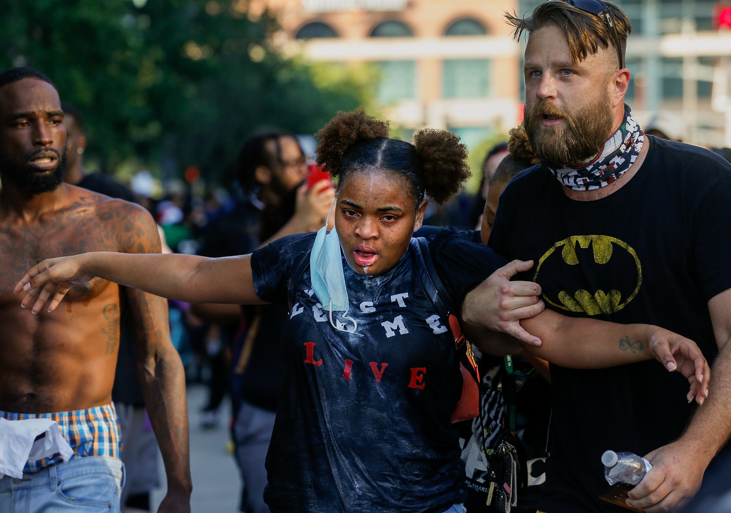 A woman is helped after she was pepper sprayed by Houston Police officers on Tuesday, June 2, 2020, in Houston, Texas. This was the fifth day of protests across the nation sparked by the death of former Houston resident George Floyd. He died while i