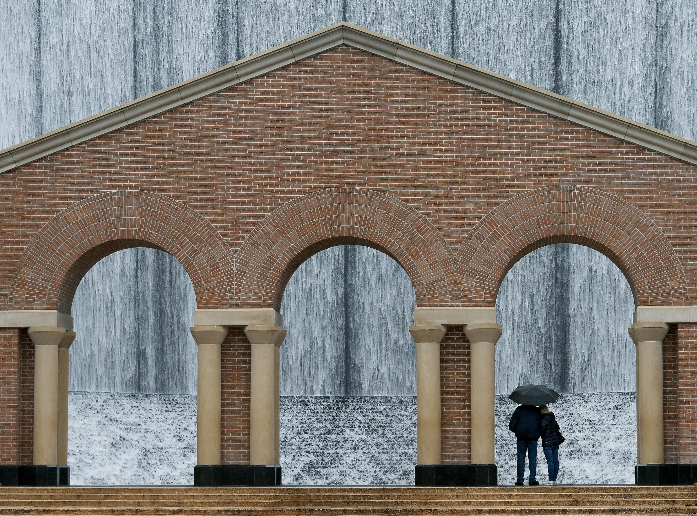  Art Solda, 72, left, and his fiancee Tatiana braved the rain to check out the Williams Tower Water Wall on Wednesday, Jan. 22, 2020, in Houston, Texas. The couple was traveling to Savannah, Georgia, where they will be getting married in early Februa