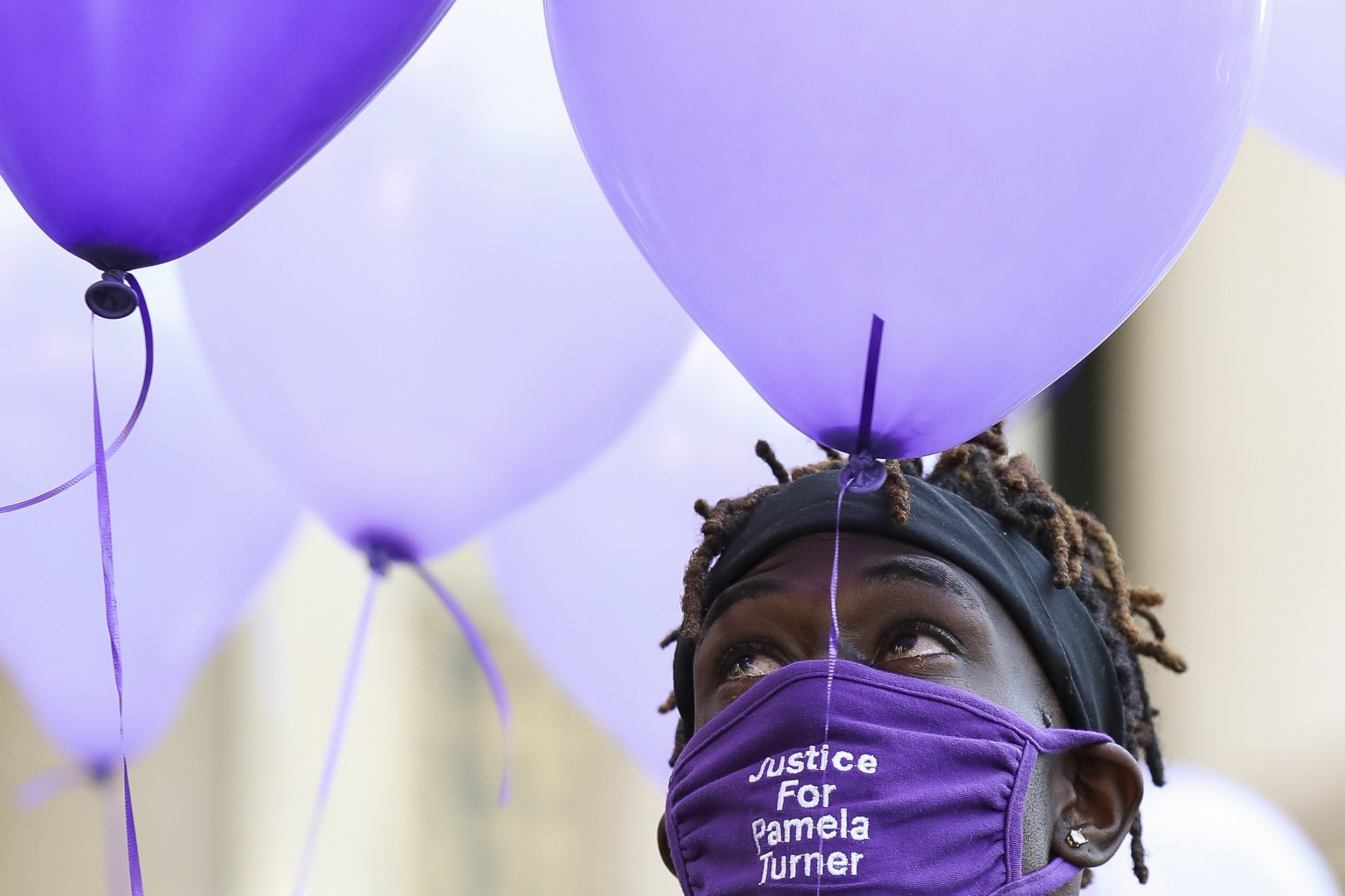 Cameron January looks toward the sky, waiting to release balloons to commemorate what would have been the 46th birthday of Pamela Turner — his mother — after a press conference in which attorney Benjamin Crump announced the filing of a federal lawsu