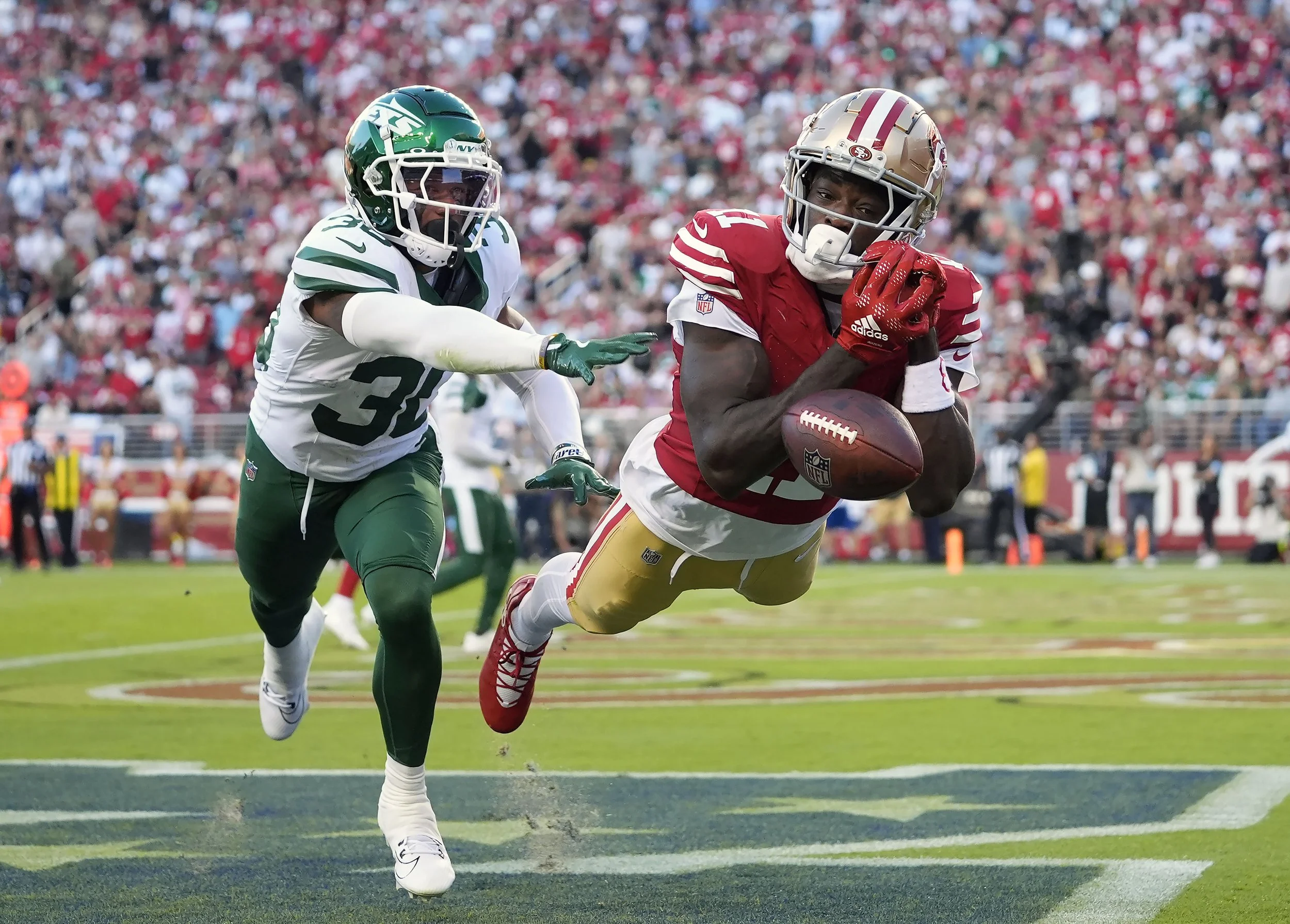 San Francisco 49ers wide receiver Brandon Aiyuk, right, cannot catch a pass against New York Jets cornerback Michael Carter II in the end zone during the first half of an NFL football game in Santa Clara, Calif., Monday, Sept. 9, 2024. (AP Photo/God
