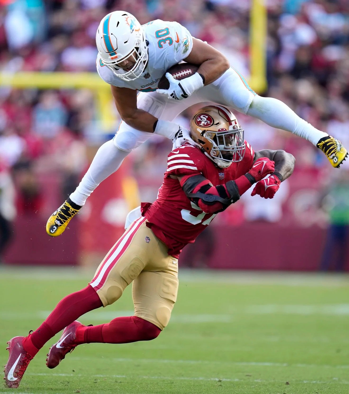 Miami Dolphins fullback Alec Ingold (30) hurdles over San Francisco 49ers linebacker Dre Greenlaw during the first half an NFL football game in Santa Clara, Calif., Sunday, Dec. 4, 2022. (AP Photo/Godofredo A. Vásquez)