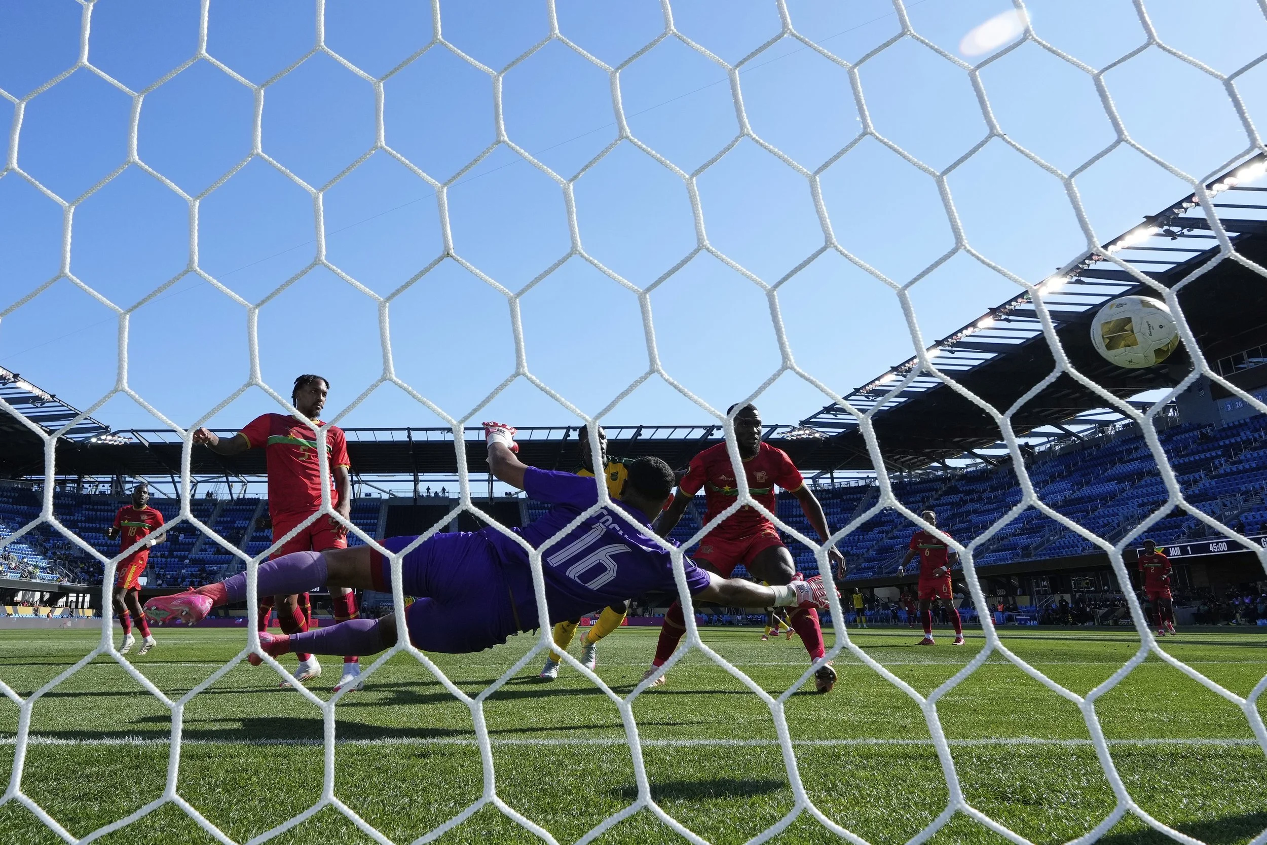 Guadeloupe goalkeeper Brice Cognard (16) is unable to make a save on a goal by Jamaica midfielder Jonathan Russell during the first half of a CONCACAF Gold Cup soccer match Friday, June 20, 2025, in San Jose, Calif. (AP Photo/Godofredo A. Vásquez)
