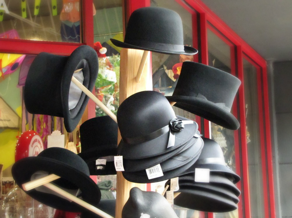 historic black hats by shop window