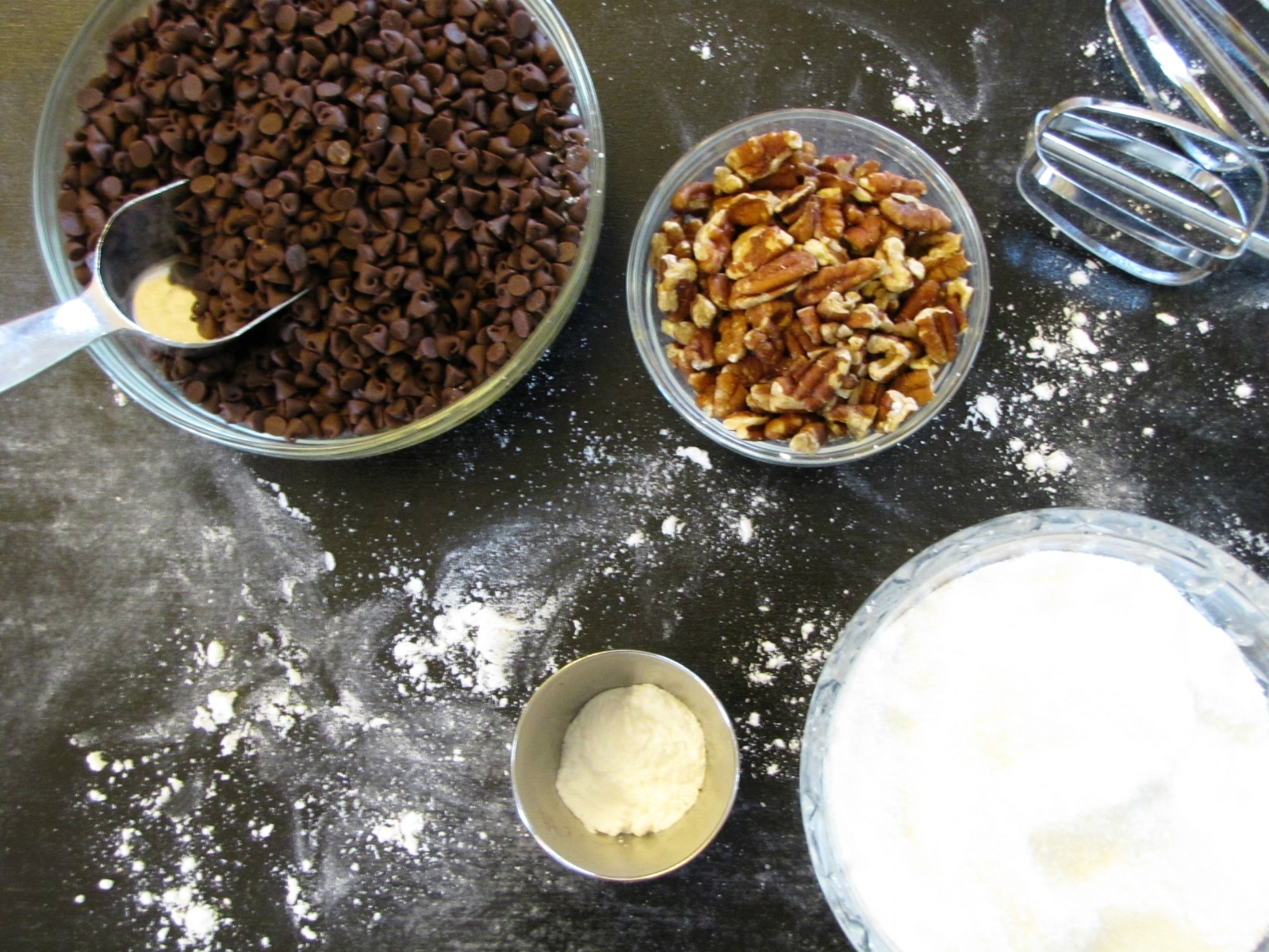 chocolate chips, nuts, and sugar in bowls