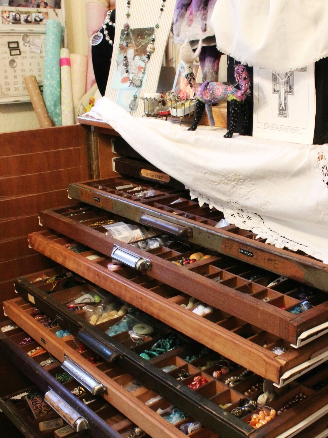 art studio letterpress drawers filled with beads and knicknacks