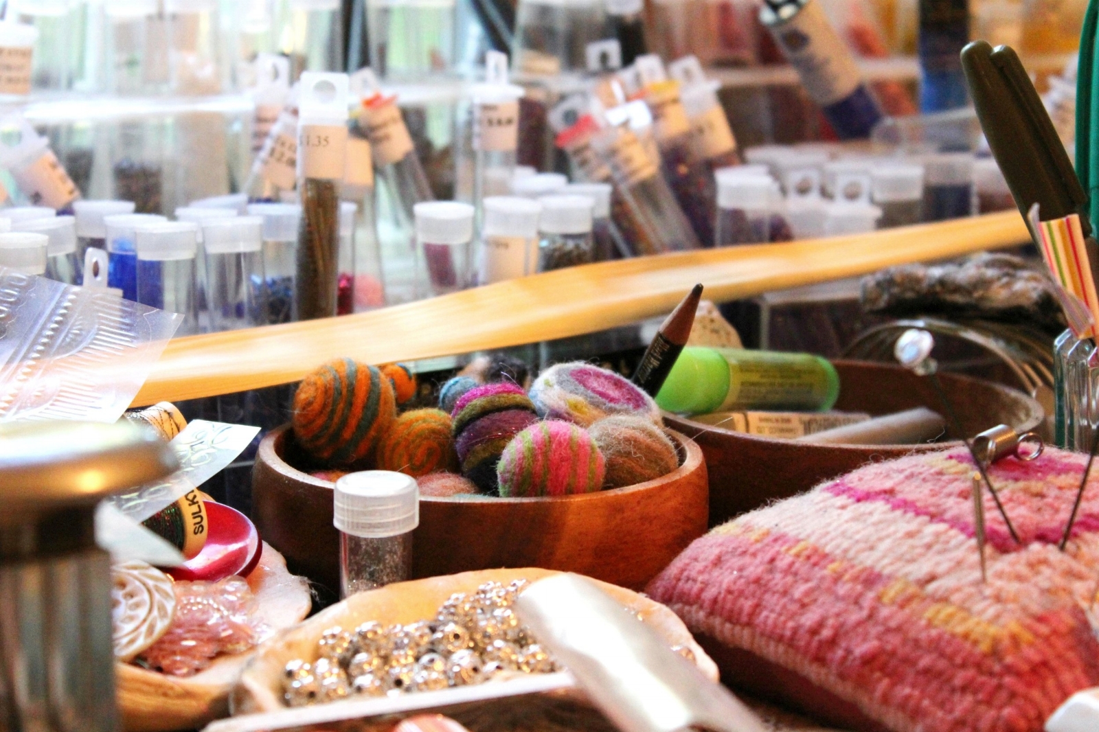 colorful felted wool spheres and beads in art studio