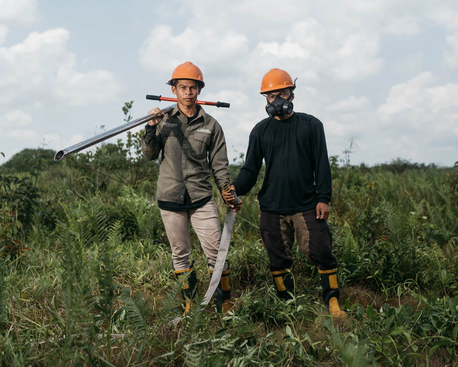 Portrait of Agus (left) and his friend during a firefighting drill at a guard house near peat swamp forest of PT Rimba Makmur Utama.