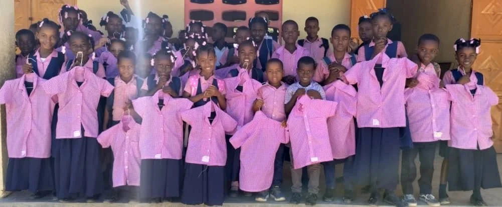 Copy of handing out uniforms.JPG