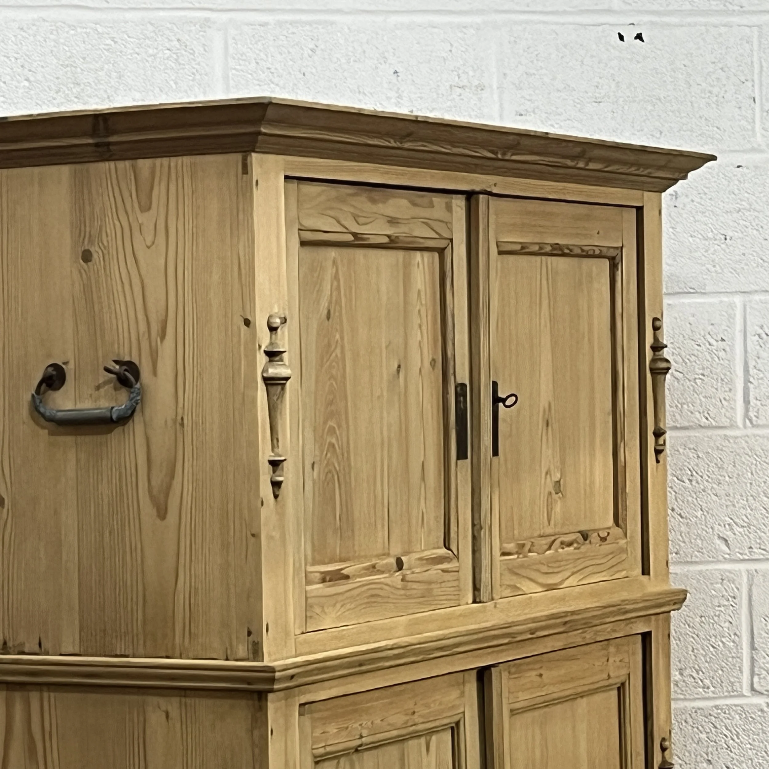 Detail of the pine campaign cupboard upper doors and moulded cornice