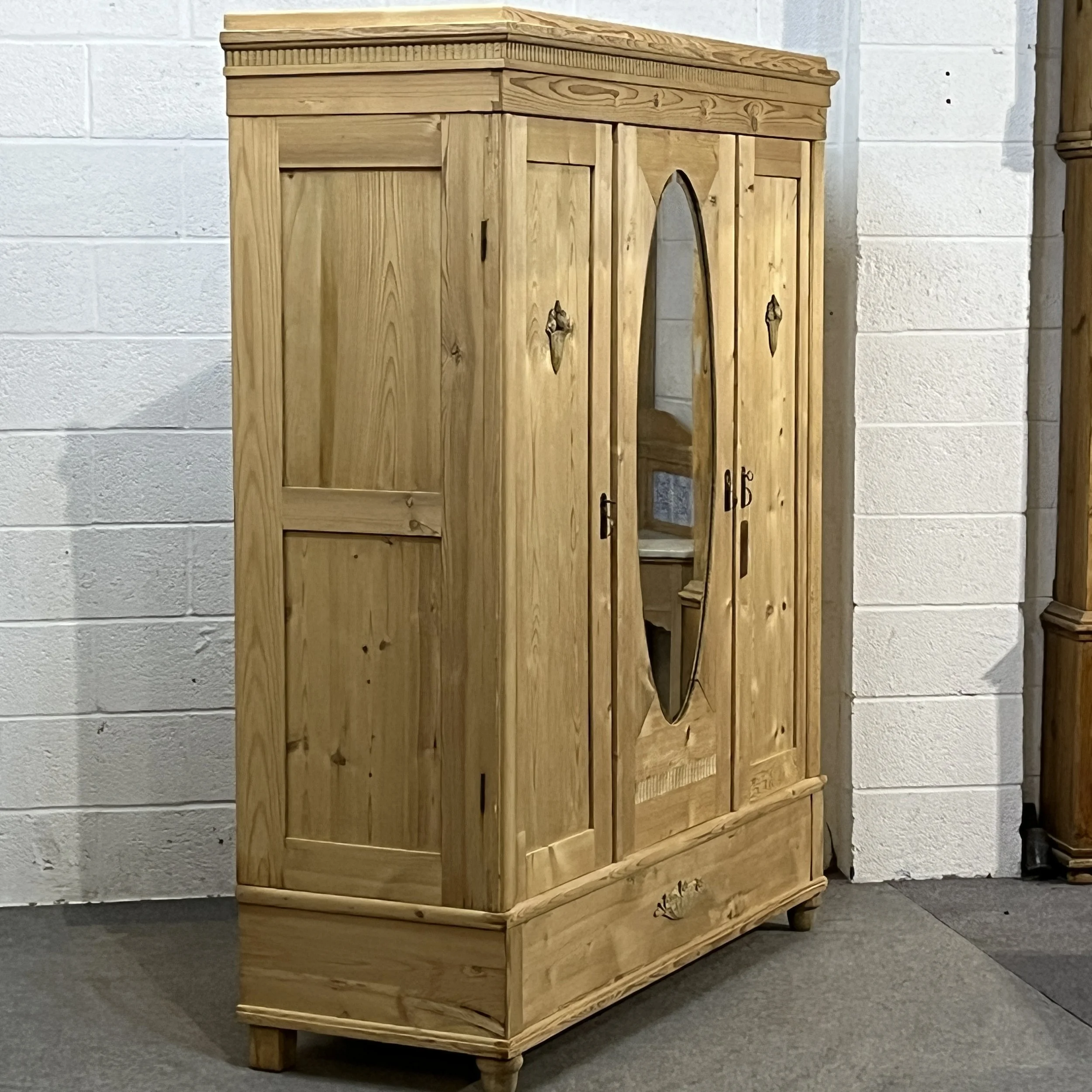 Opposite angled view of the mirrored pine wardrobe showing its left side