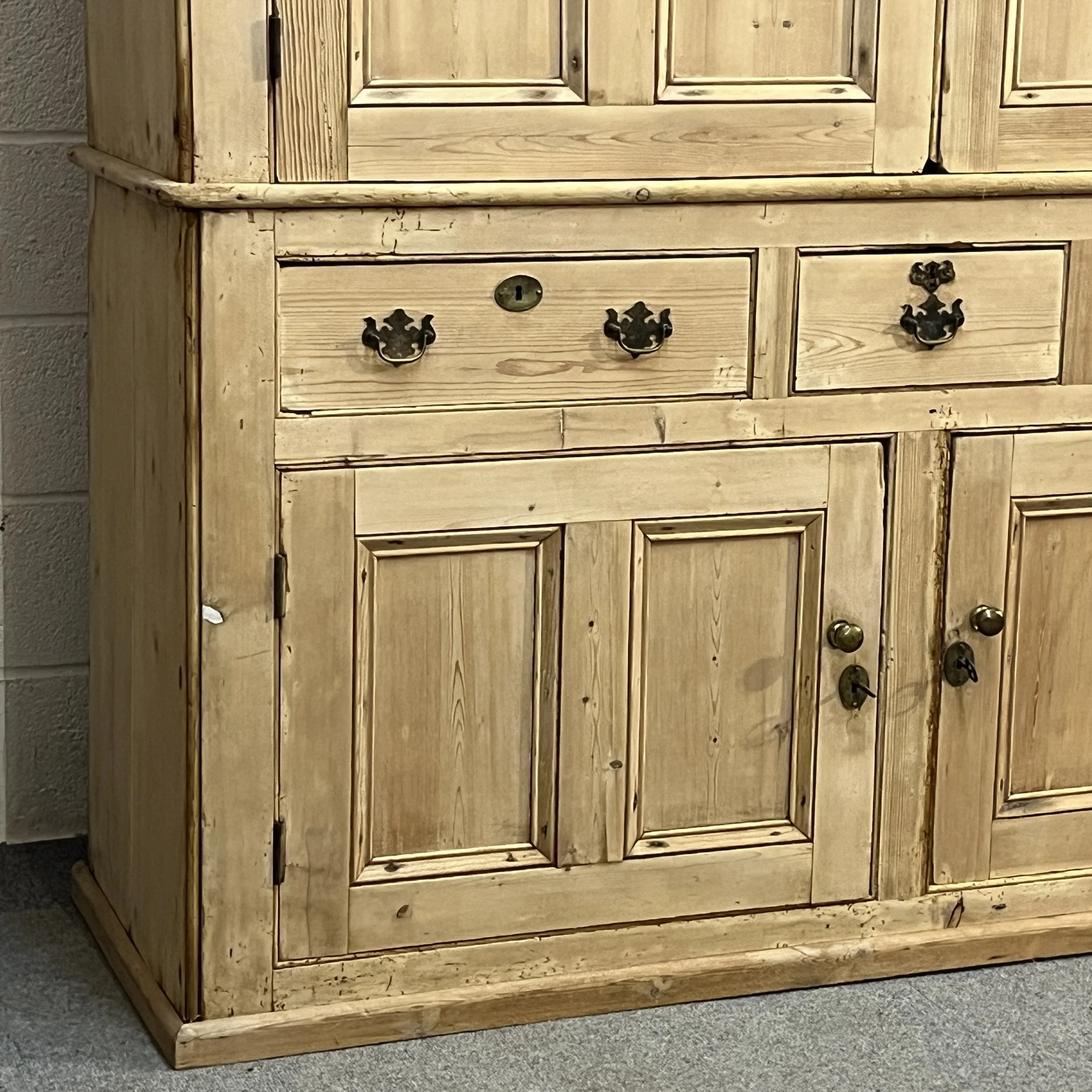 Lower doors and drawers showing brass fittings and old wear on pine cupboard N7700I
