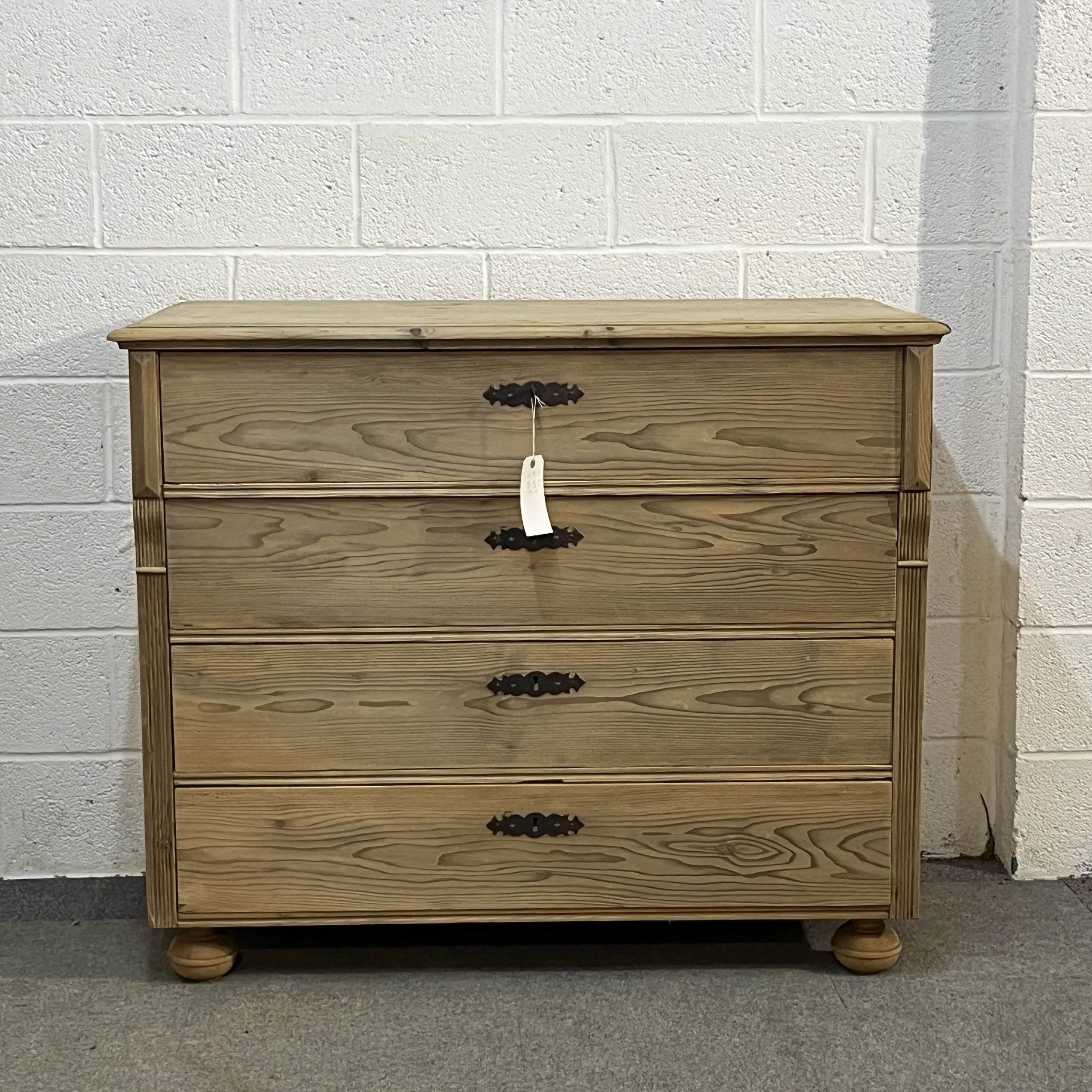 Front view of antique pine chest N7308C with dark escutcheons and bun feet