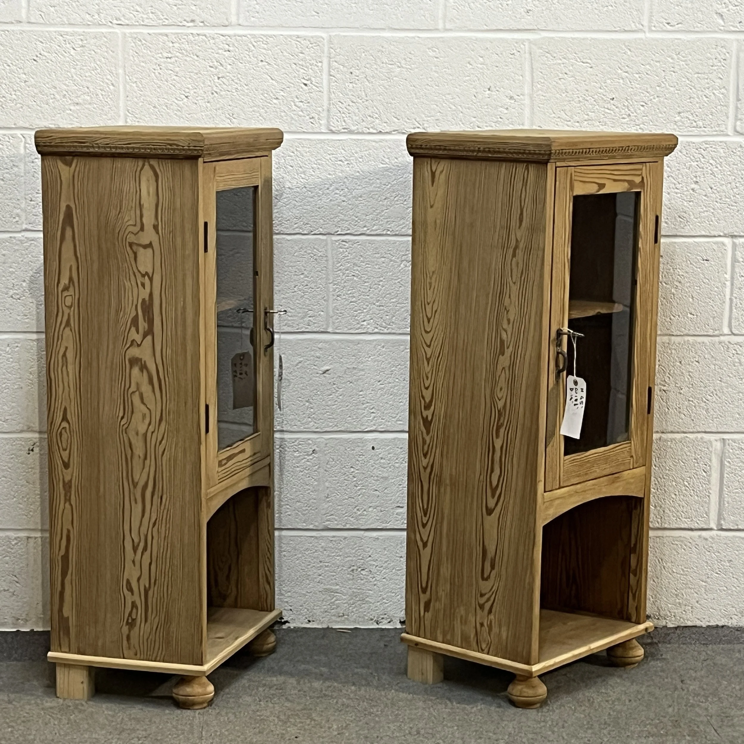 Opposite angled view of the two pine glazed cabinets showing their left sides