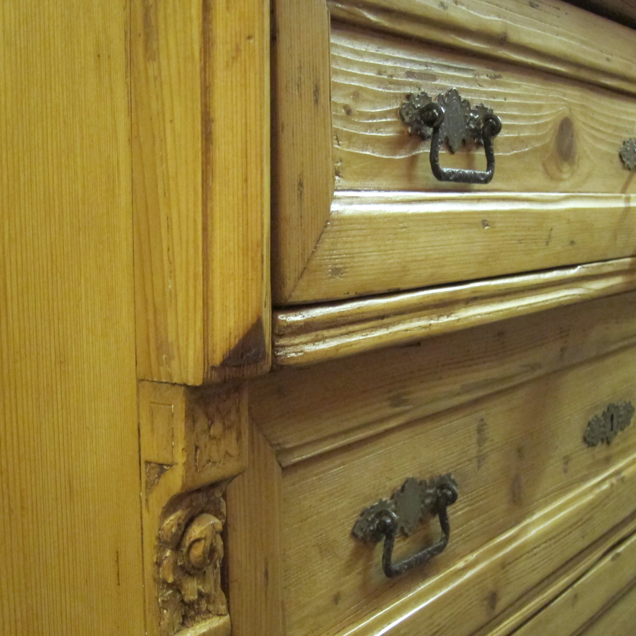 Close up waxed old pine chest of drawers