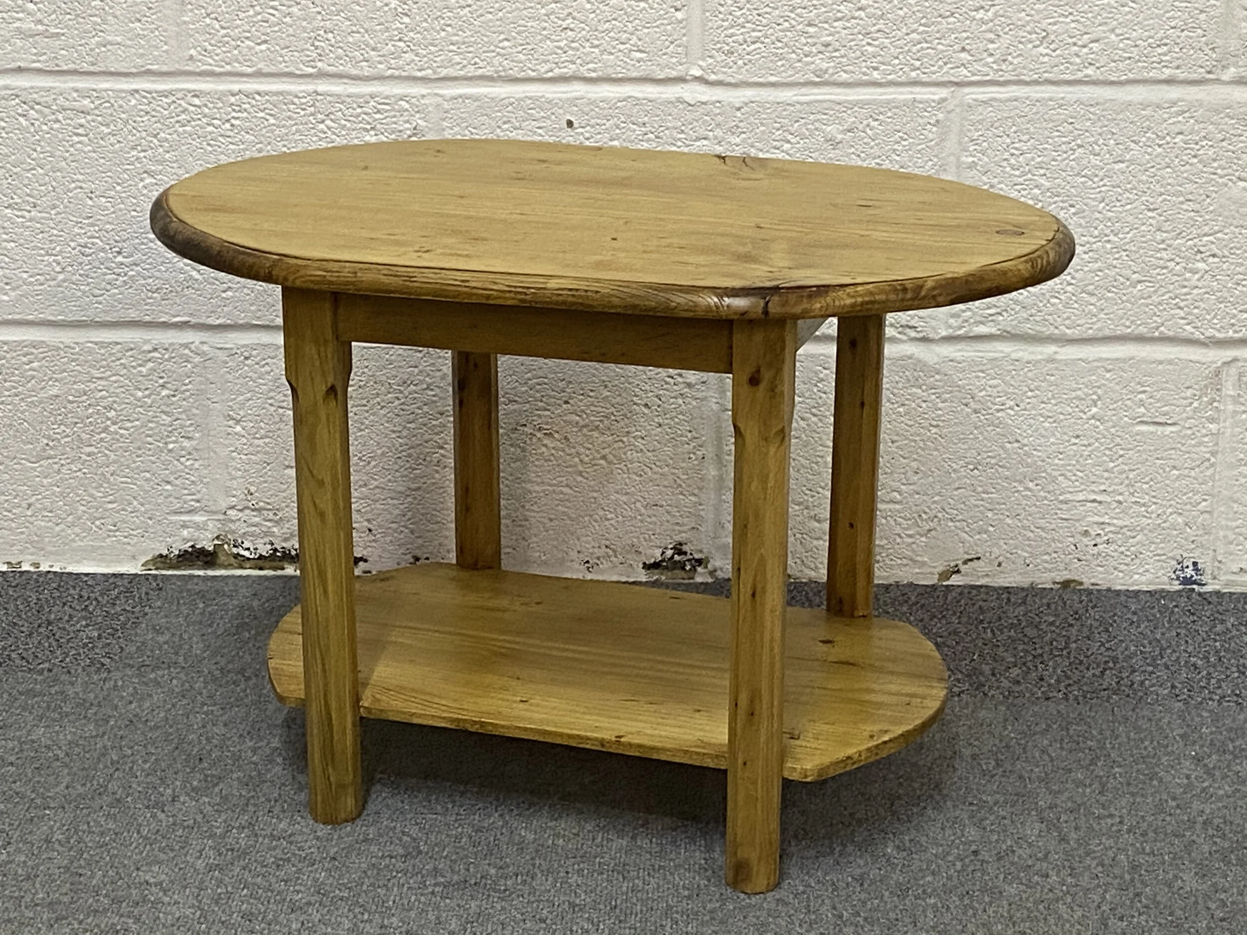 Low oval pine table with shelf below