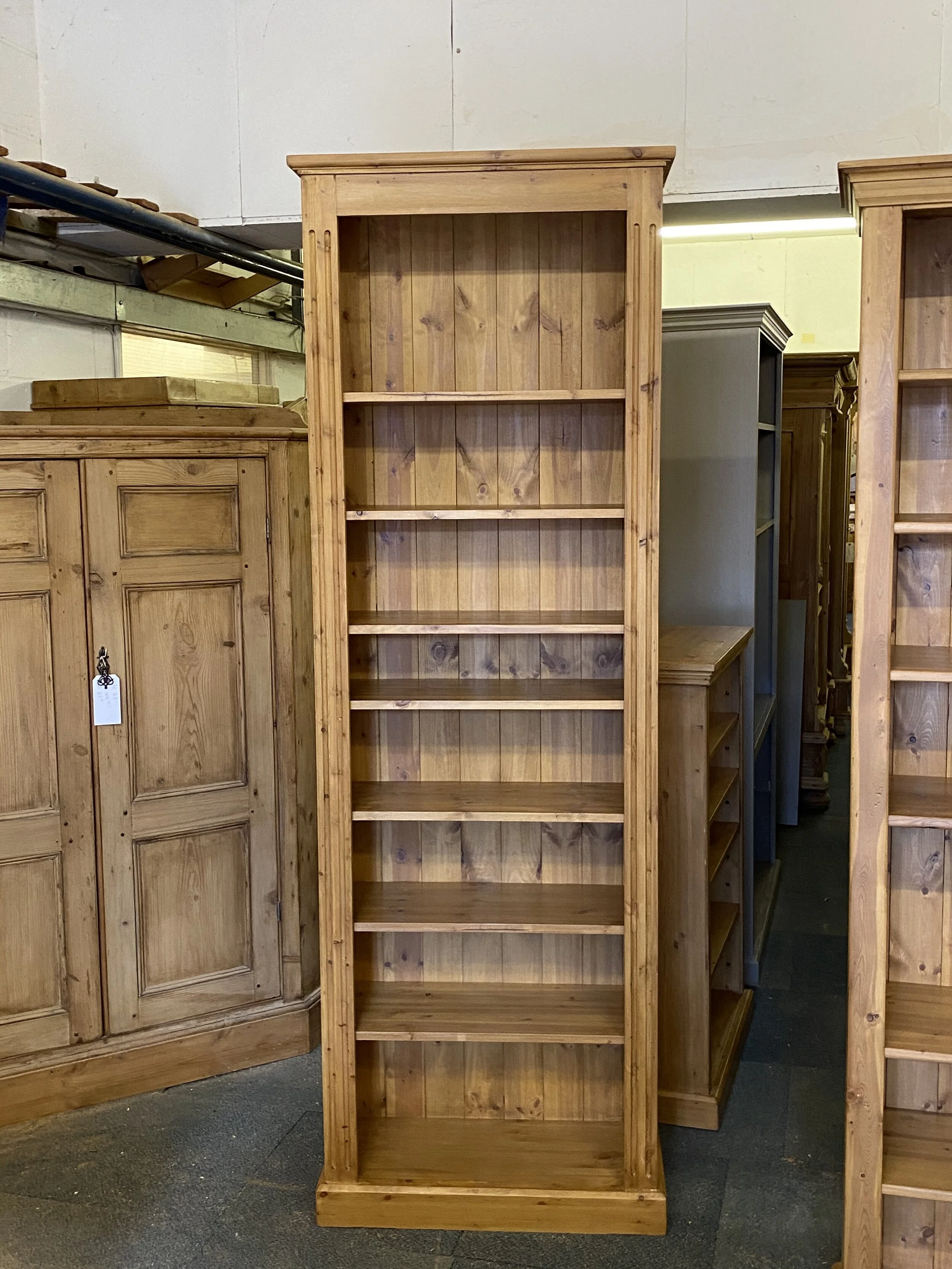 Very tall pine bookcase with adjustable shelves inside