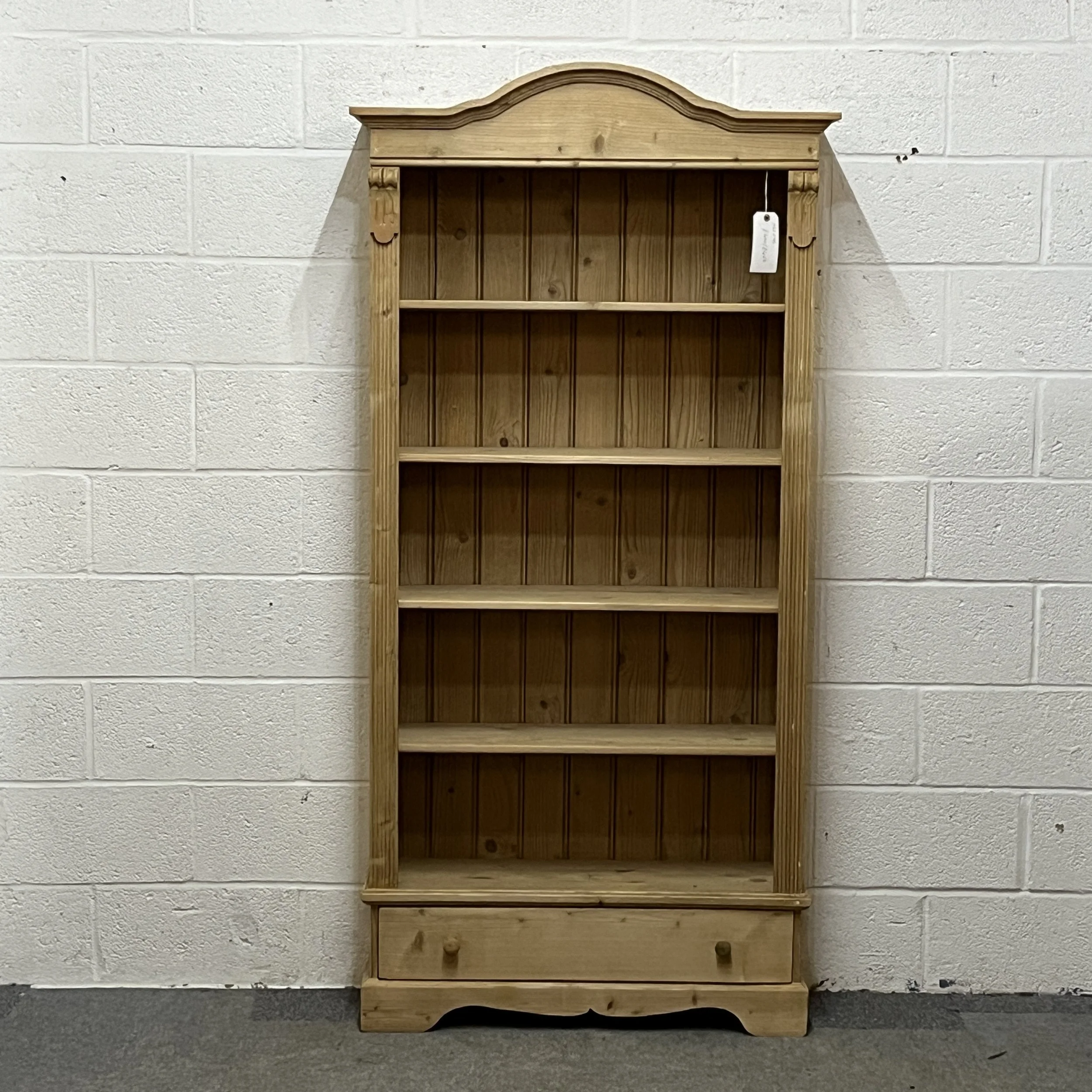 Tall Slim Arched Top Pine Bookcase With Bottom Drawer
