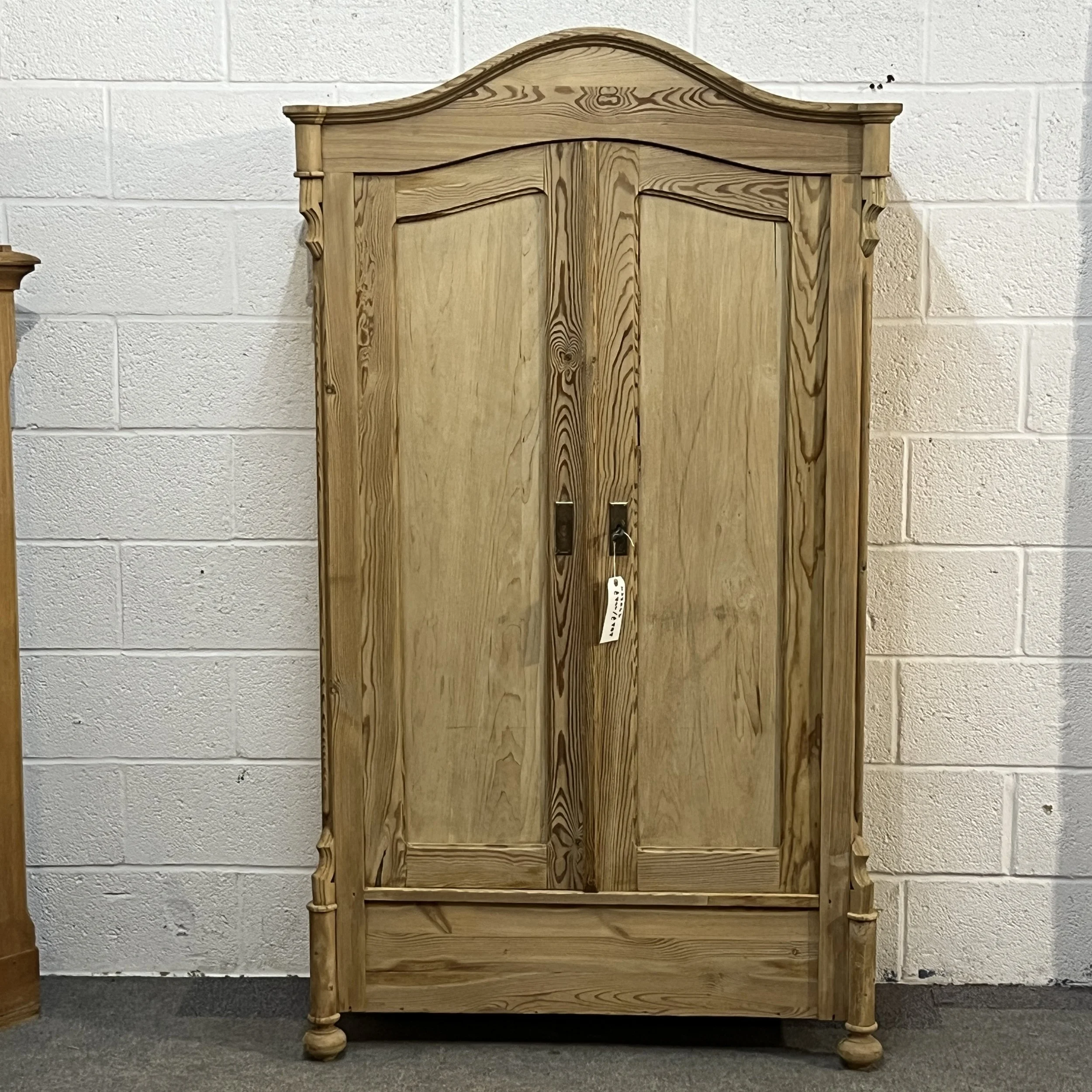 Front view of two-door antique pine armoire N3304D with arched top