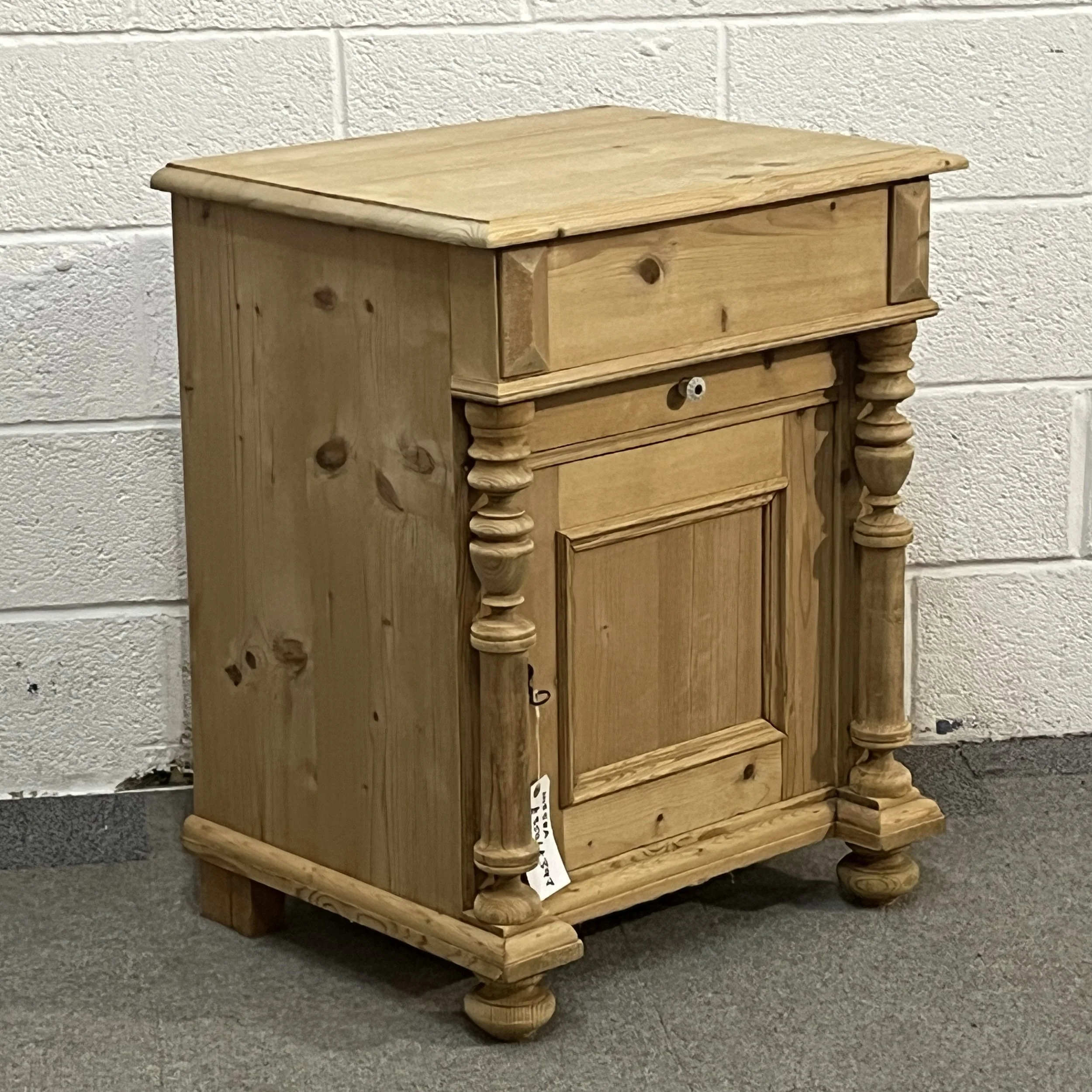 Left three-quarter view of the small antique pine wash cupboard