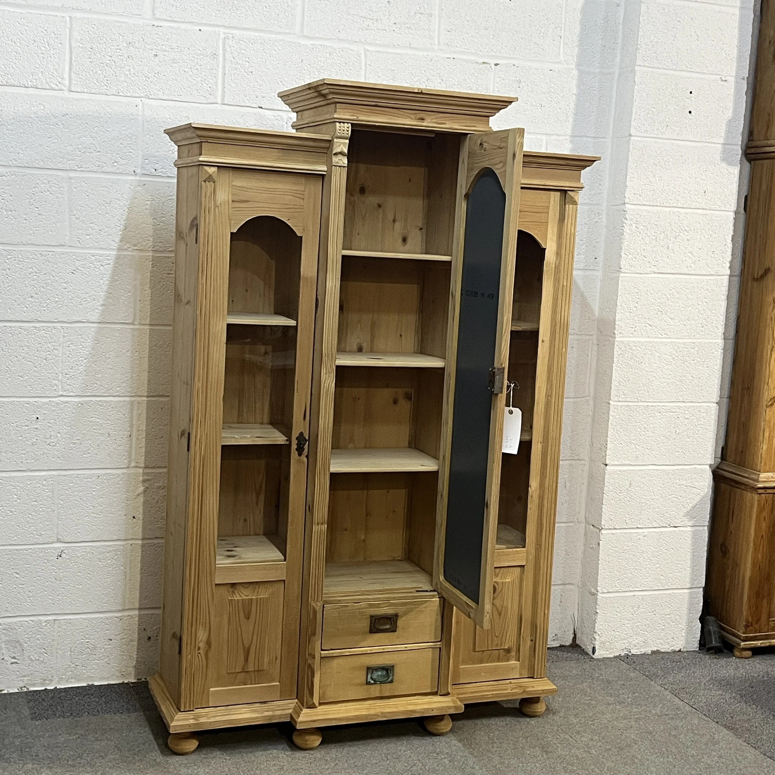 Central mirrored door open to show three cupboard shelves inside pine display cabinet N7500D