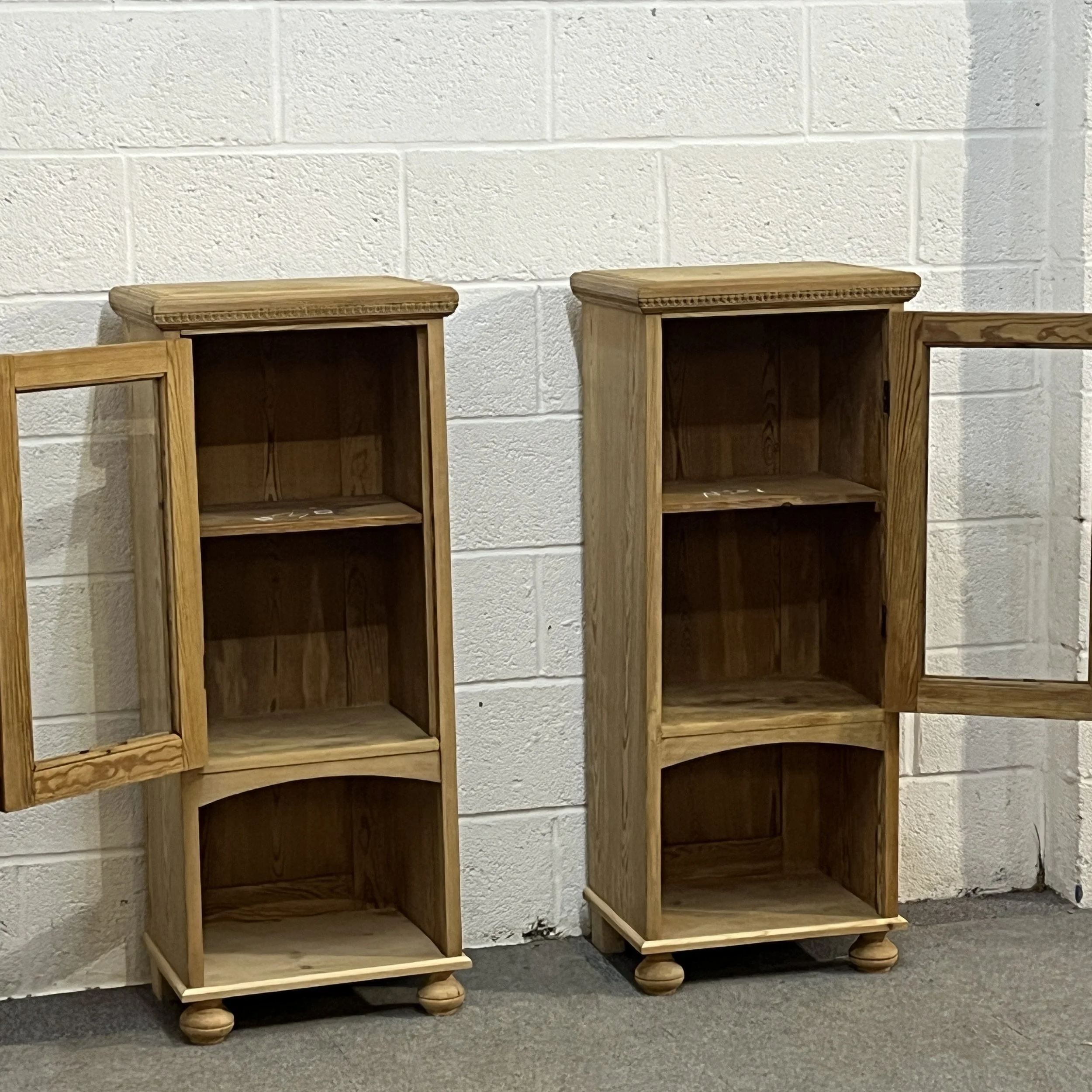 Pair of pine glazed cabinets with both doors open, showing the internal shelves