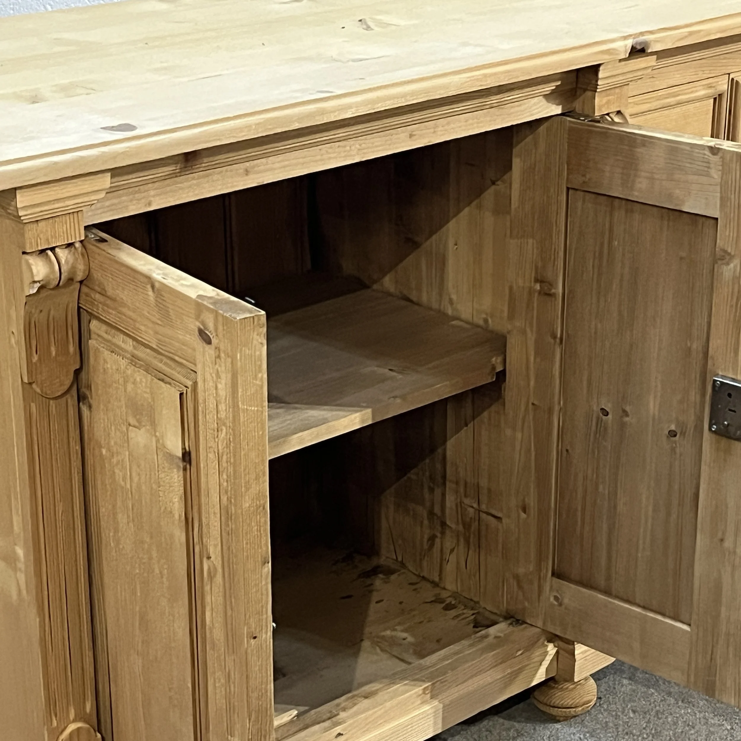 Detail of cupboard interior, shelf, door lock and carved pilaster on pine sideboard N7102E