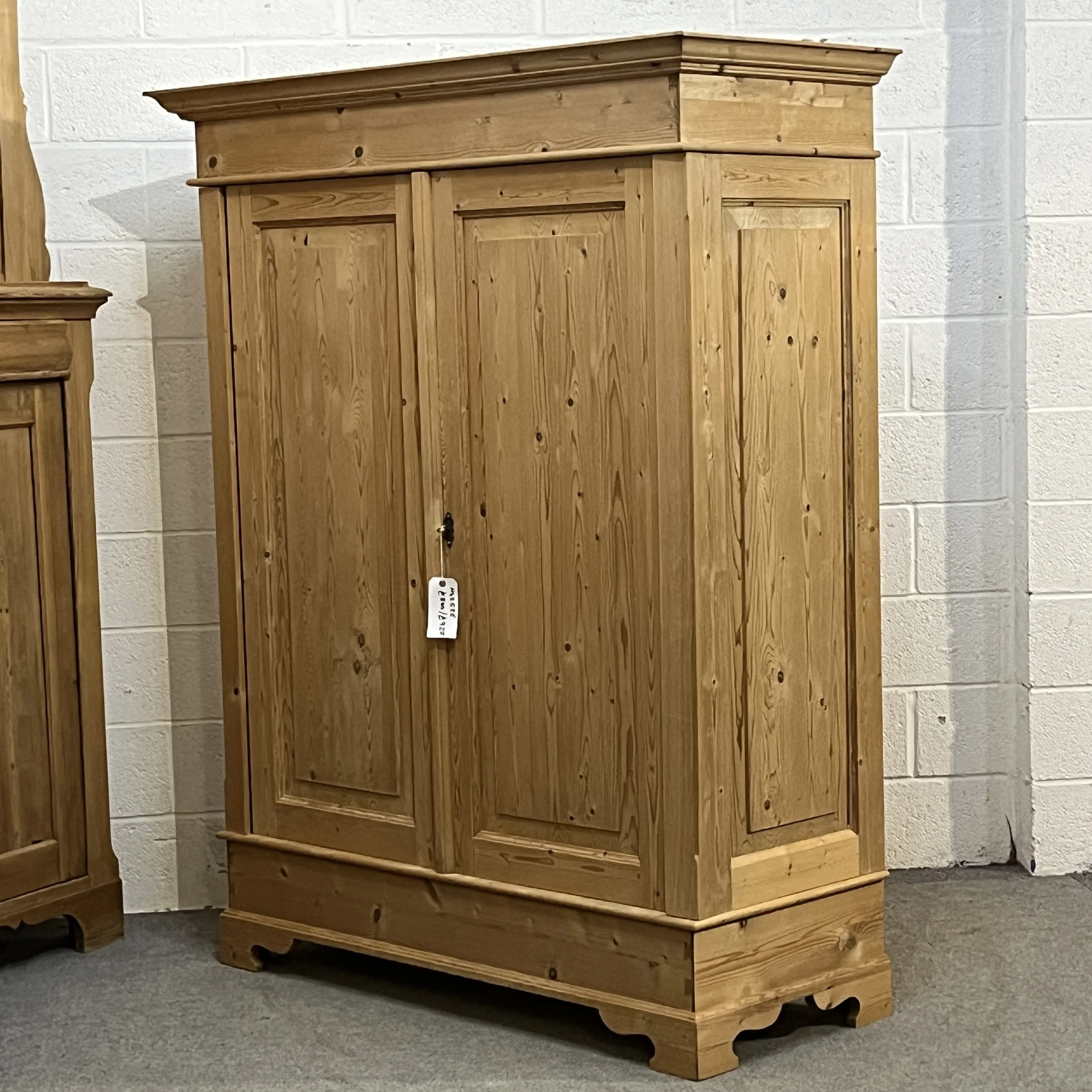 Angled view of the double pine wardrobe showing its right side and door panels