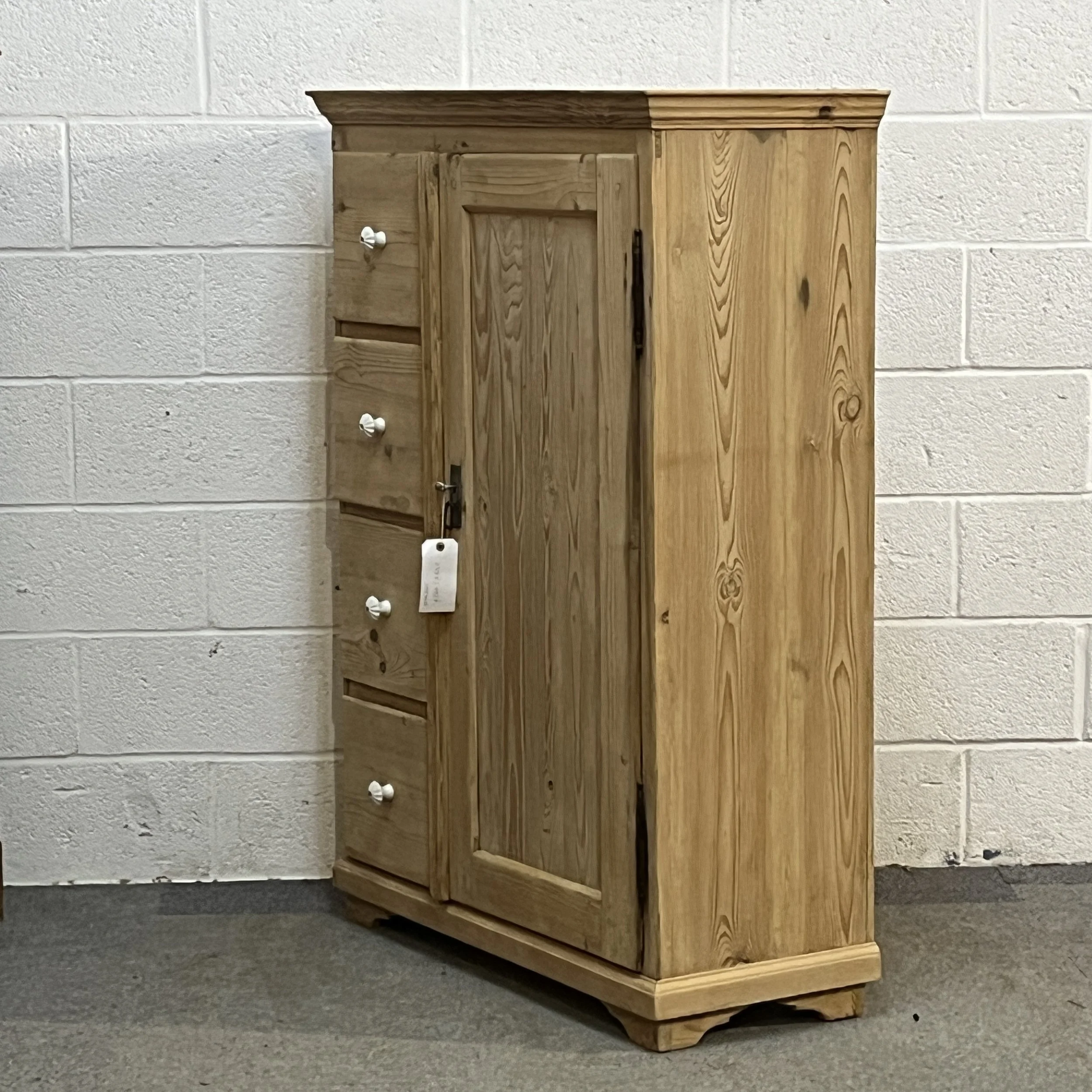Right-hand angled view of antique pine cupboard N7408C showing the solid side and external hinges