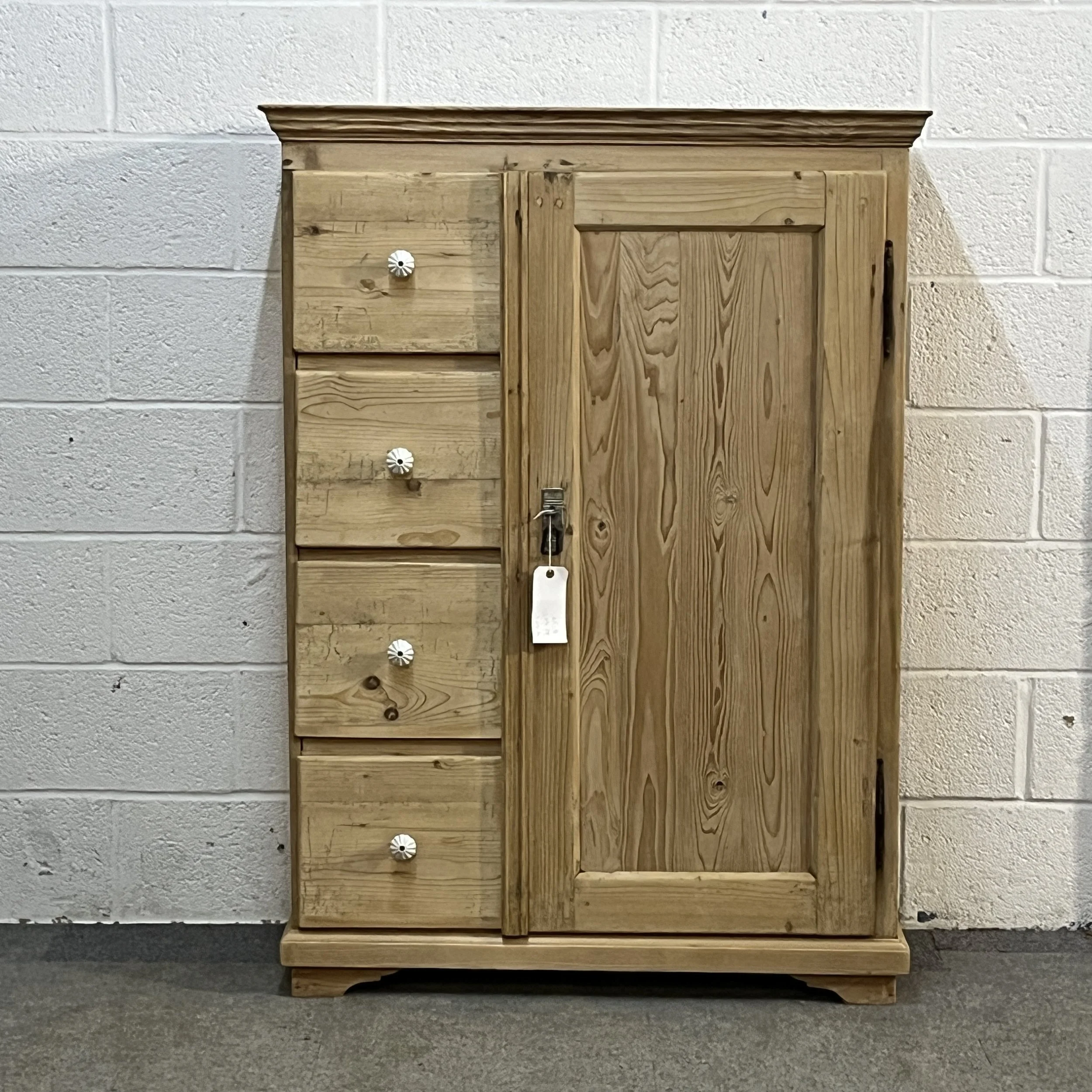 Straight-on view of antique pine larder cupboard N7408C with white ceramic knobs and shaped feet