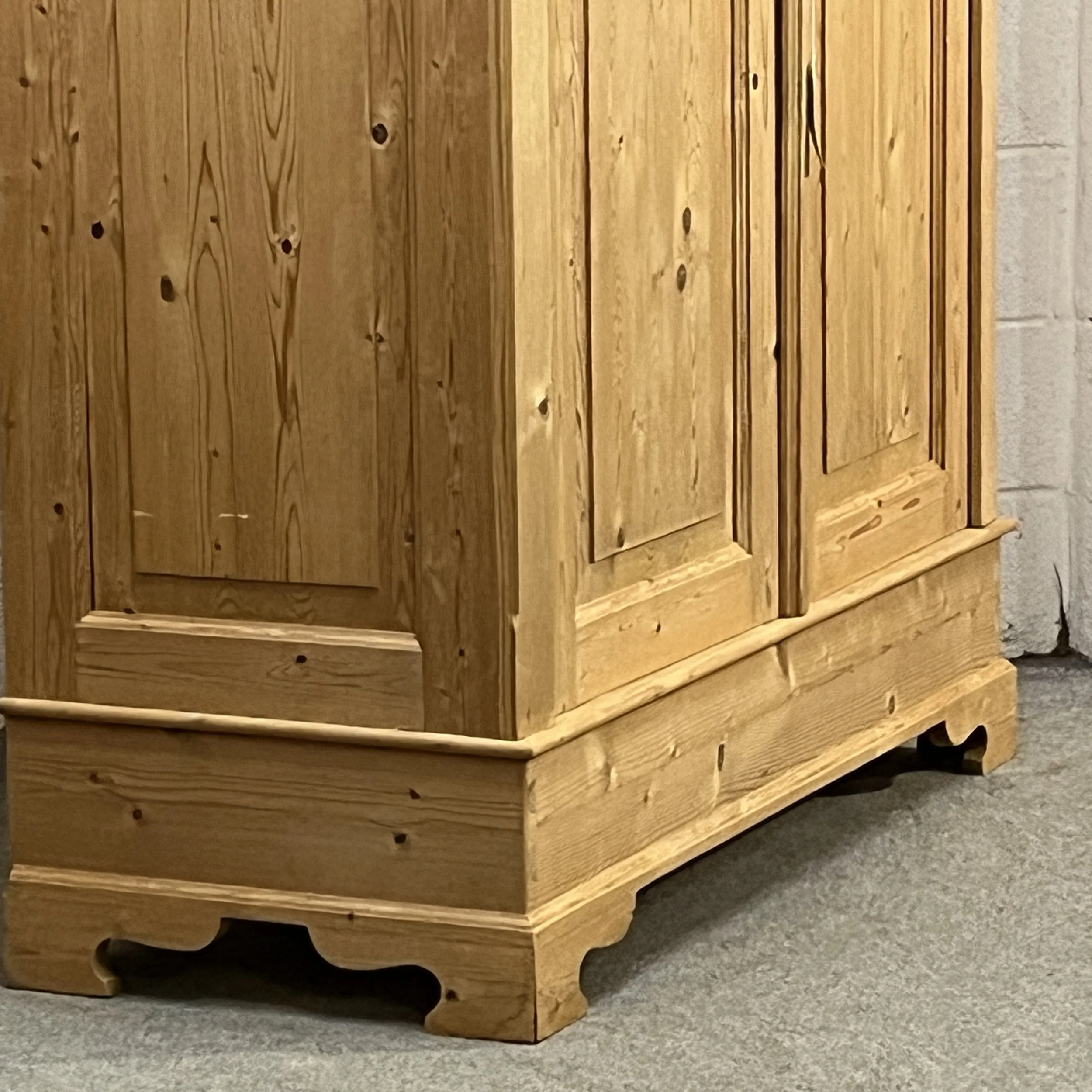 Detail of the pine wardrobe lower door panels and shaped base
